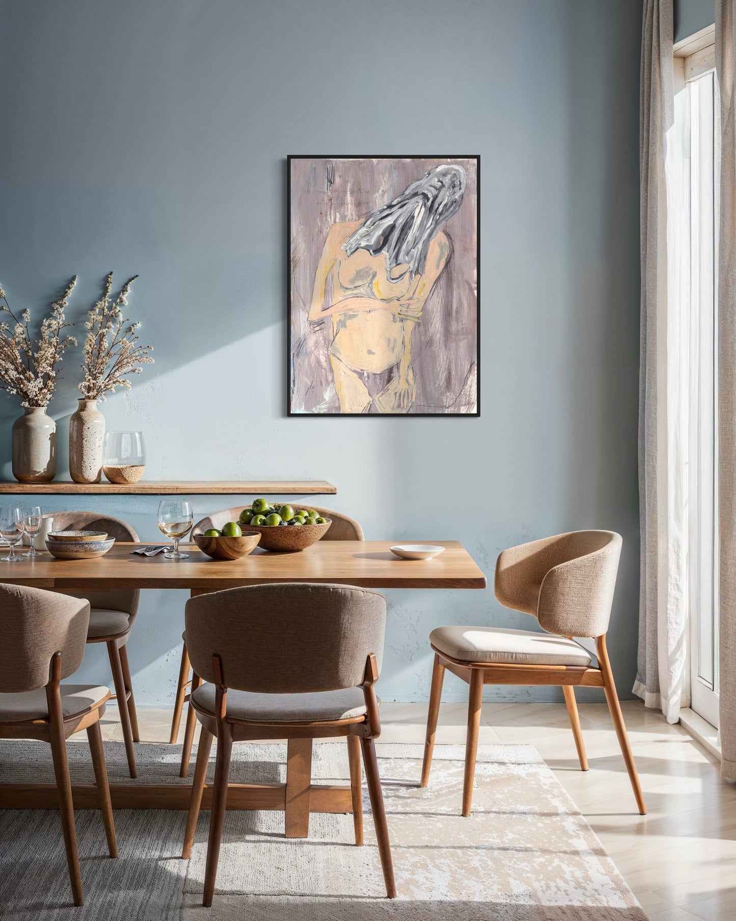 Dining room with wooden table and chairs against a light blue wall with a framed abstract painting.
