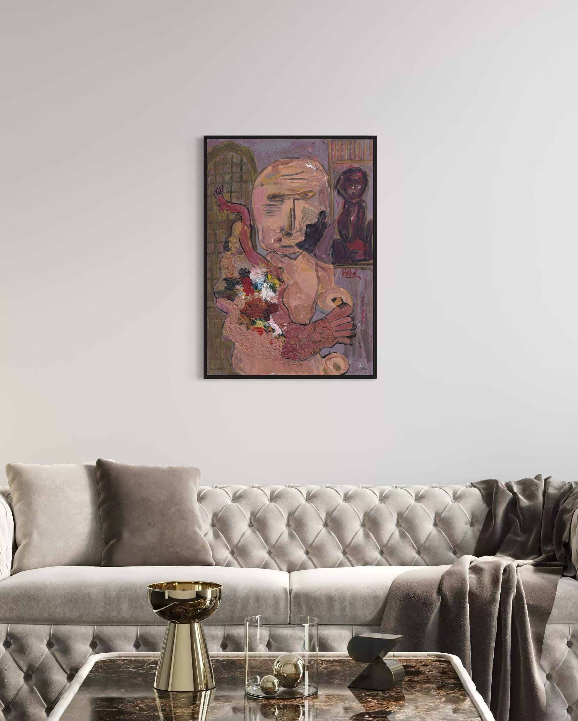 Framed artwork on a wall above a gray sofa in a living room.