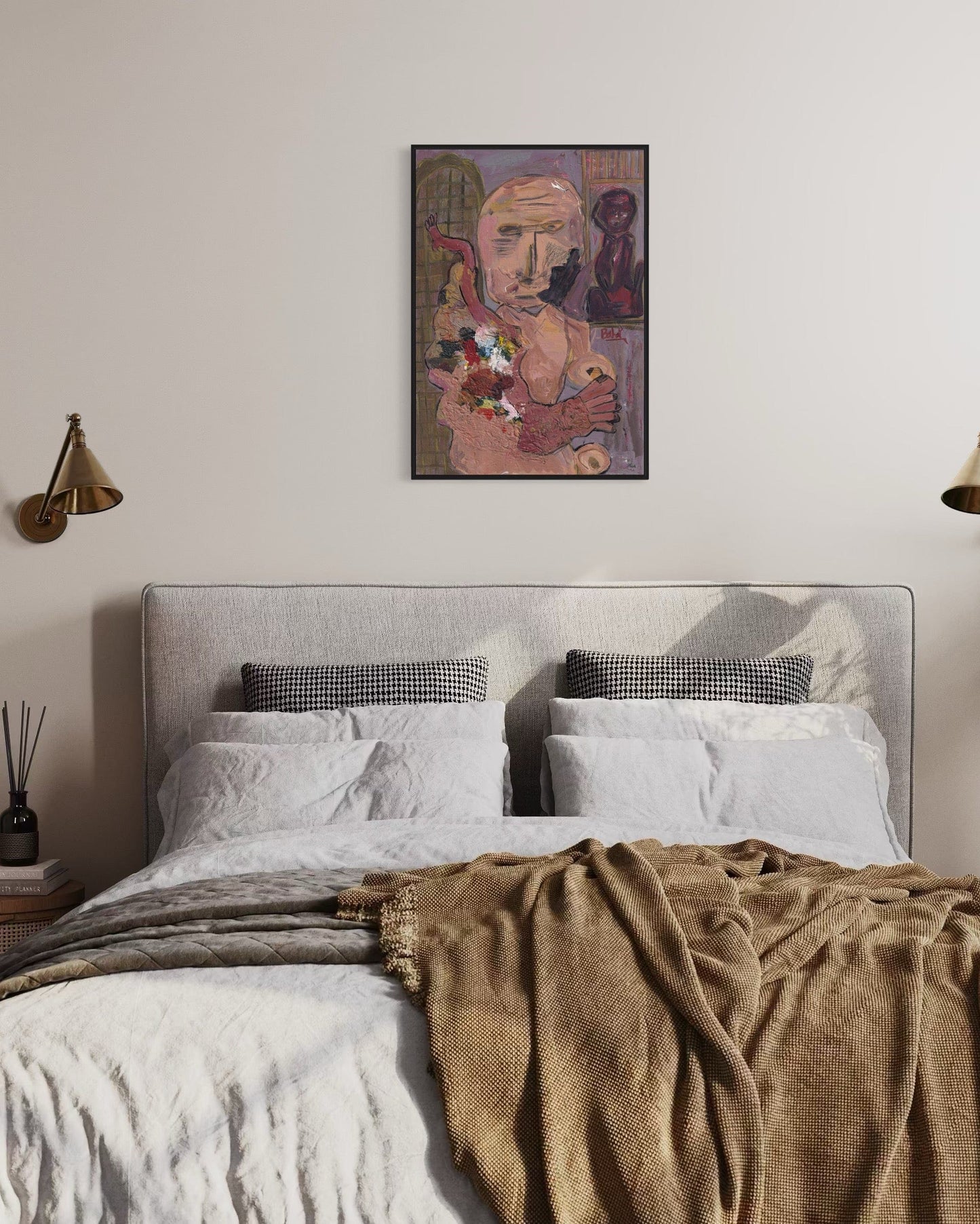 Bedroom with a bed, pillows, and a framed artwork on the wall.