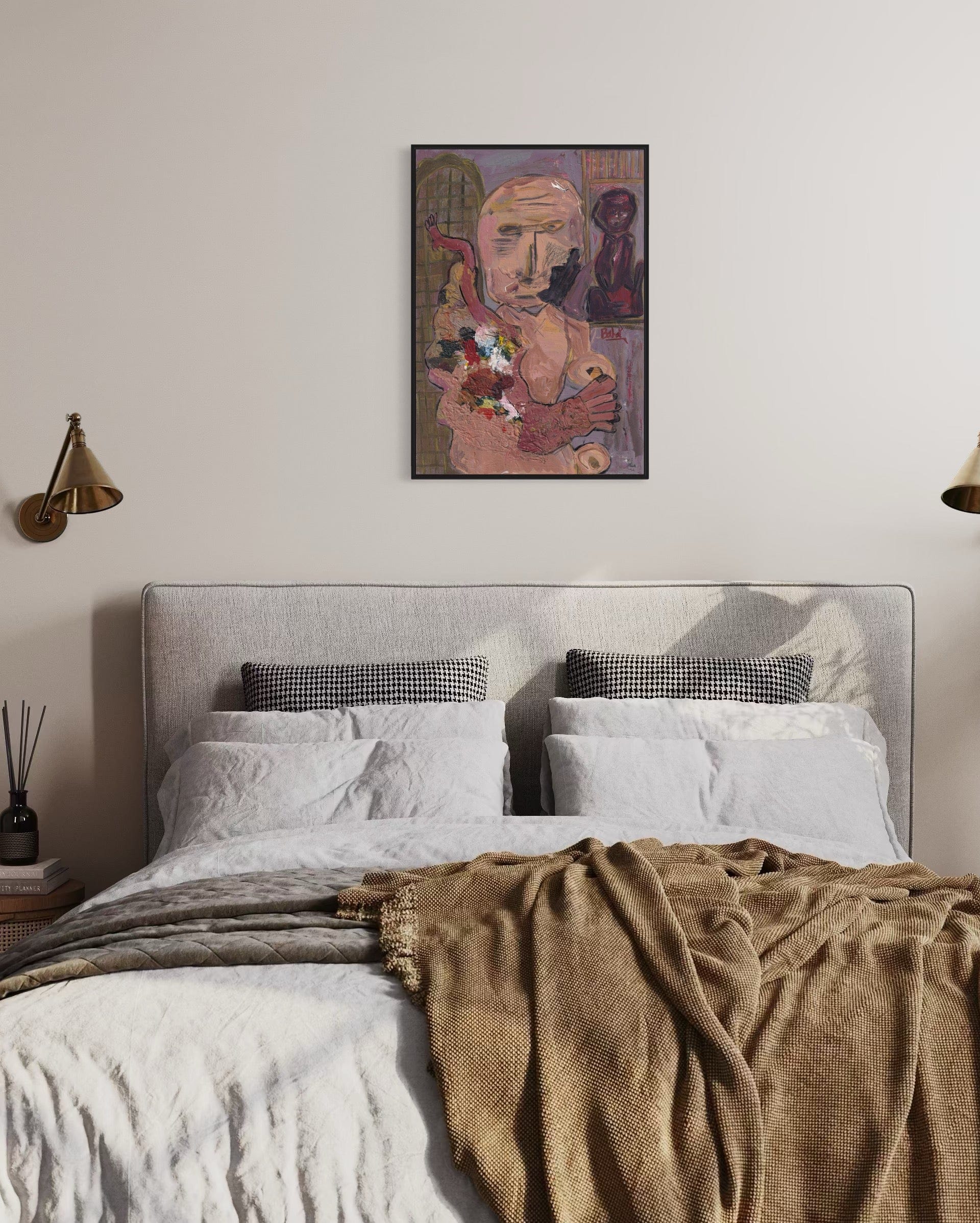 Bedroom with a bed, pillows, and a framed artwork on the wall.