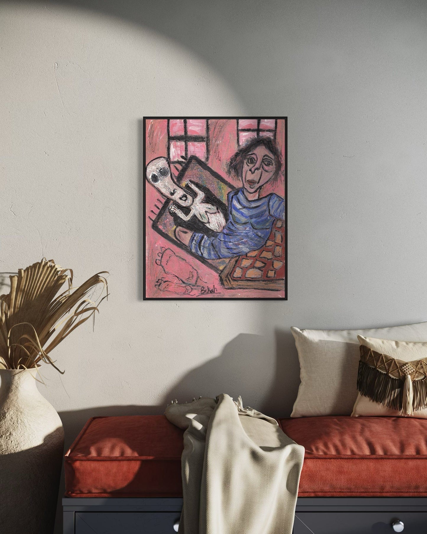 Framed artwork of a person with a dog on a pink background in a living room.