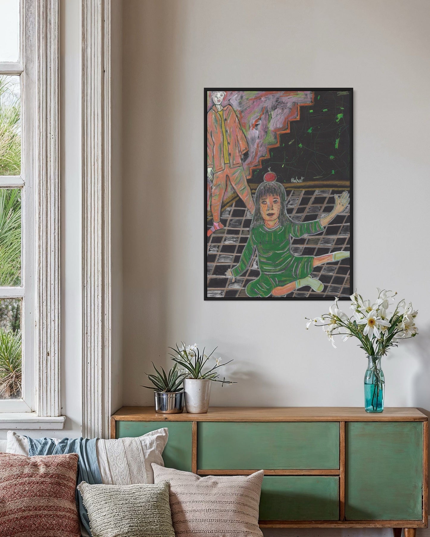 Living room with a painting on the wall, a green cabinet, and decorative items.