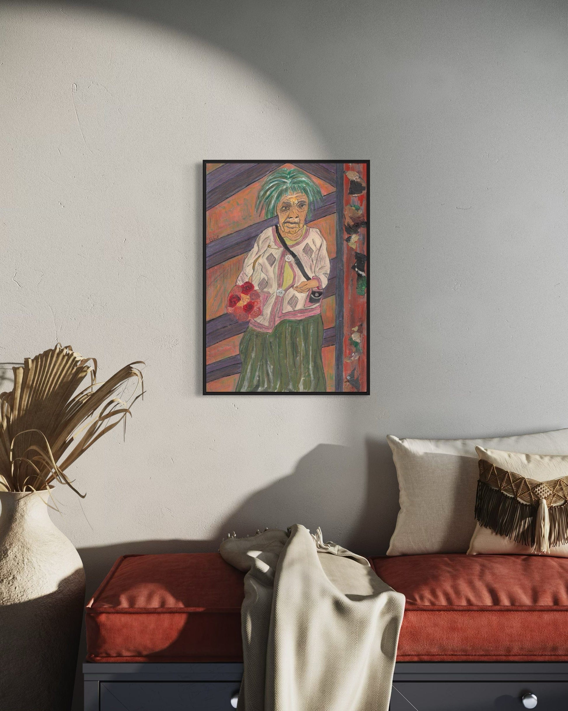 Framed artwork of a person with a colorful background in a living room setting.