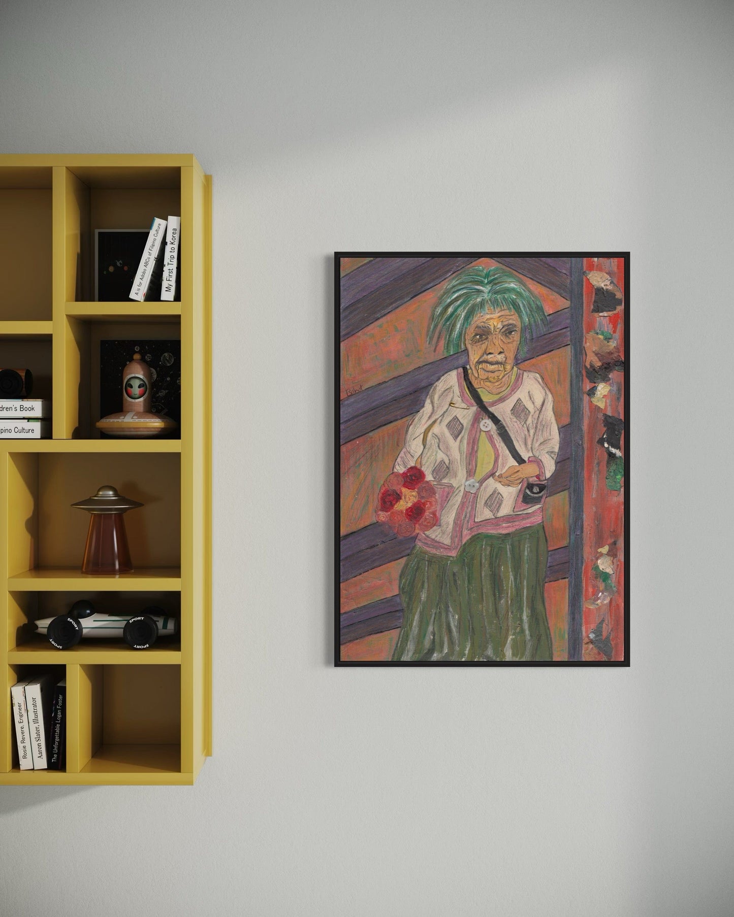 Framed artwork of a person with green hair on a wall next to a yellow bookshelf.