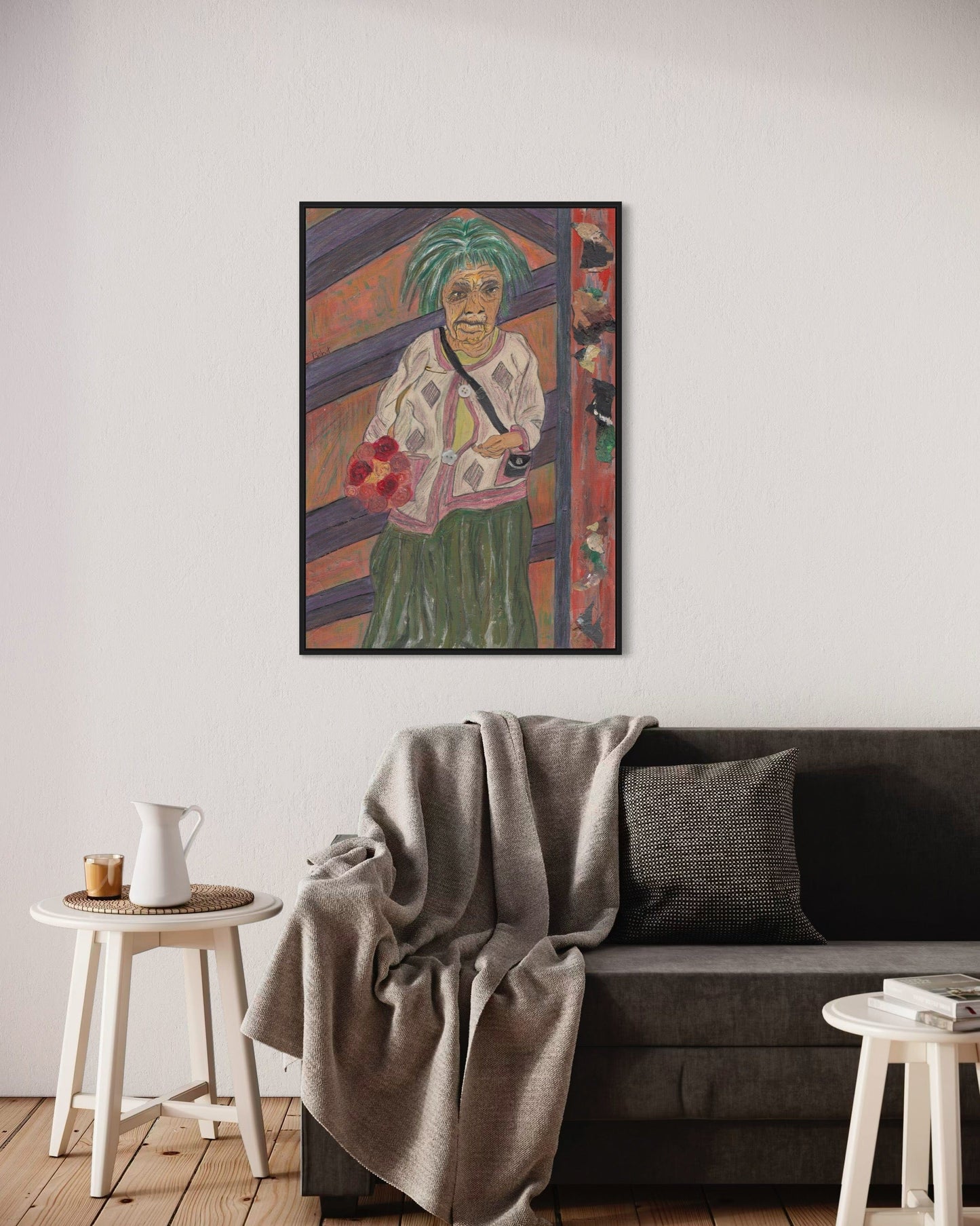 Framed artwork of a woman on a wall above a sofa in a living room.