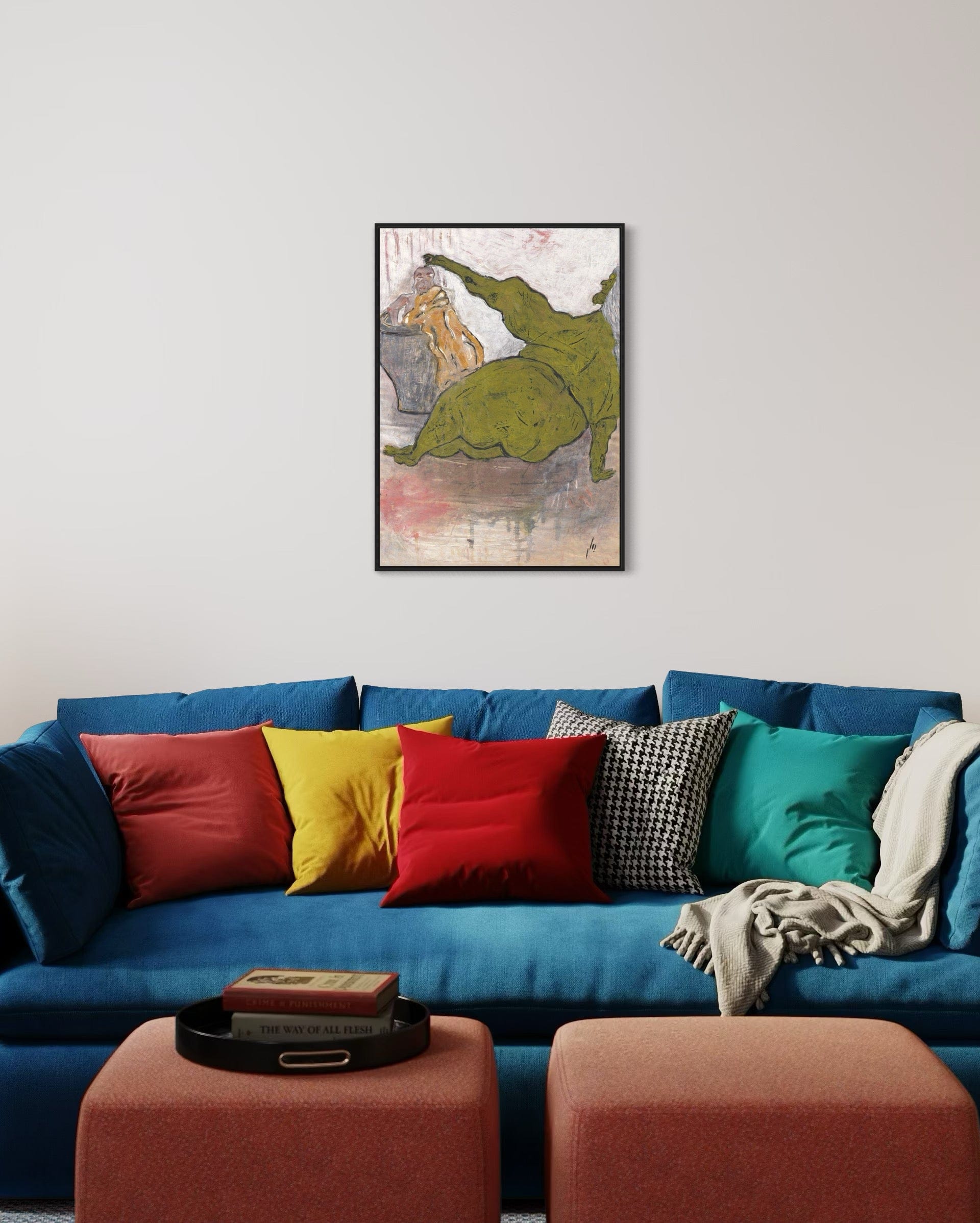 Colorful sofa with decorative pillows and a framed artwork of a green dinosaur on a white wall.