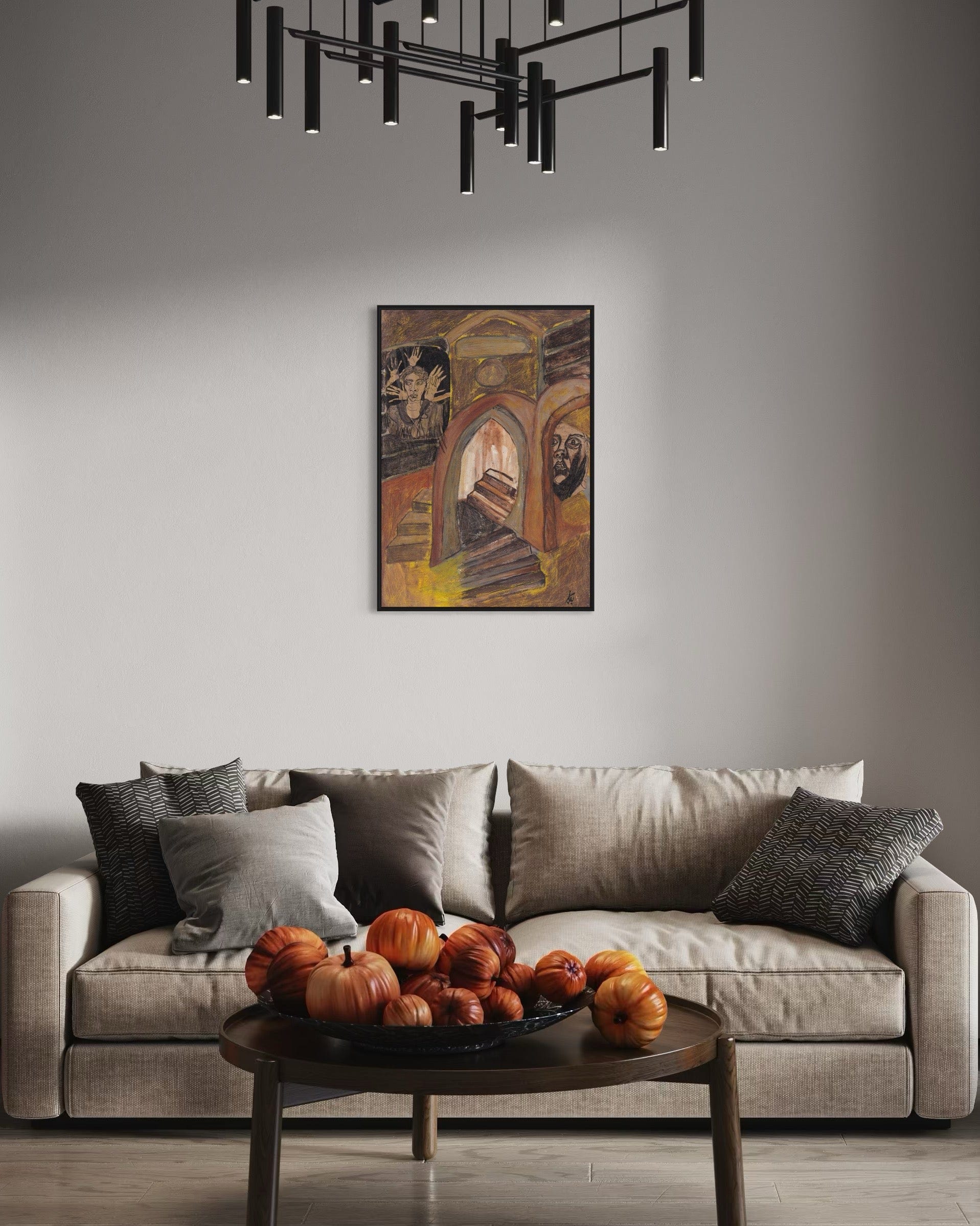 Living room with a gray sofa, decorative pumpkins on a coffee table, and a painting on the wall.