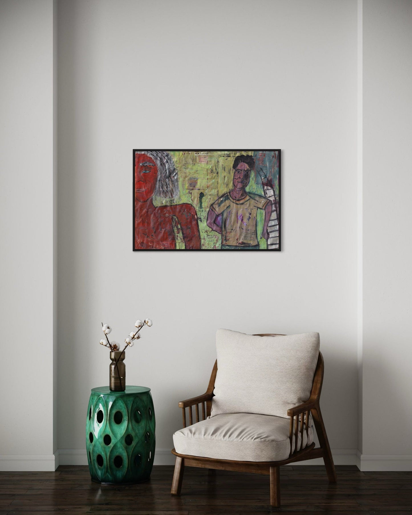 Colorful abstract painting on a wall above a chair and green side table.