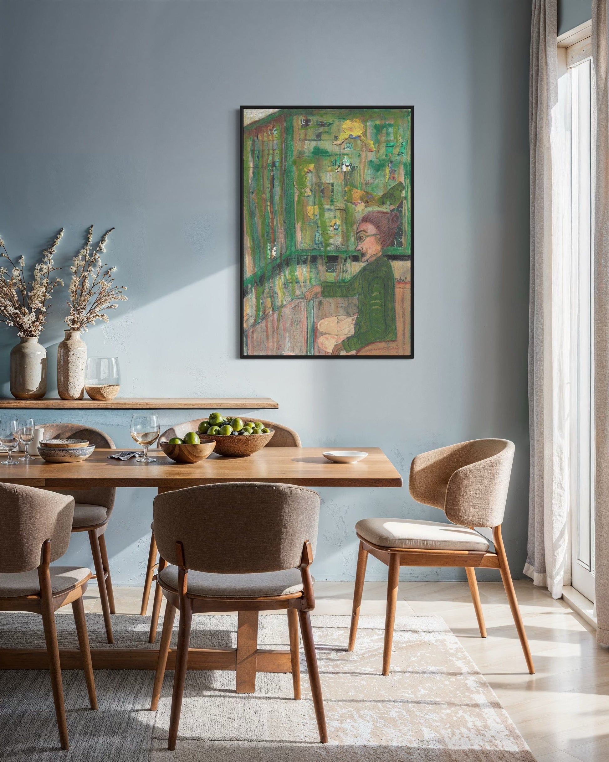 Dining room with wooden table and chairs, framed artwork on the wall, and natural light.