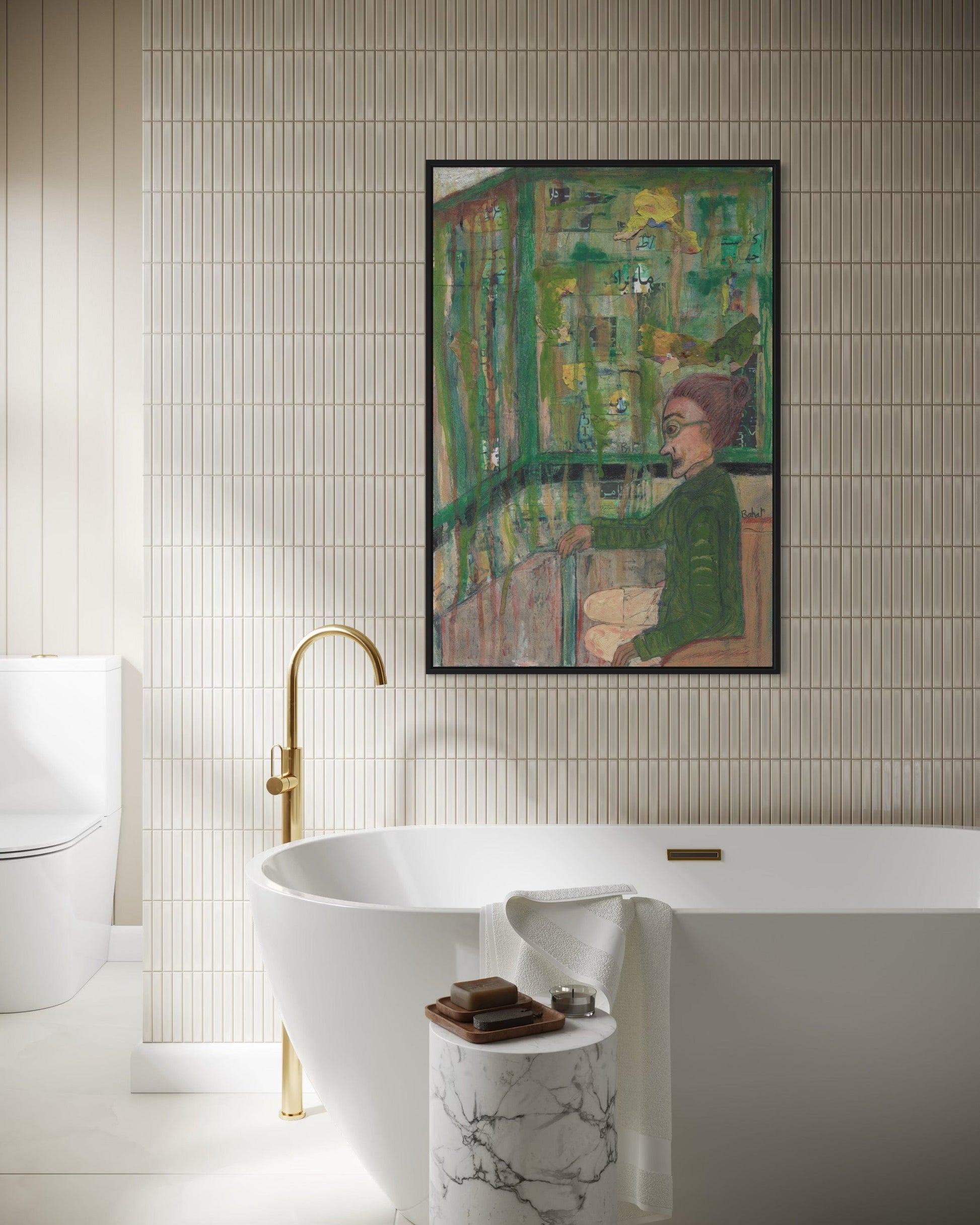 Bathroom with a freestanding bathtub, gold faucet, and framed artwork on the wall.