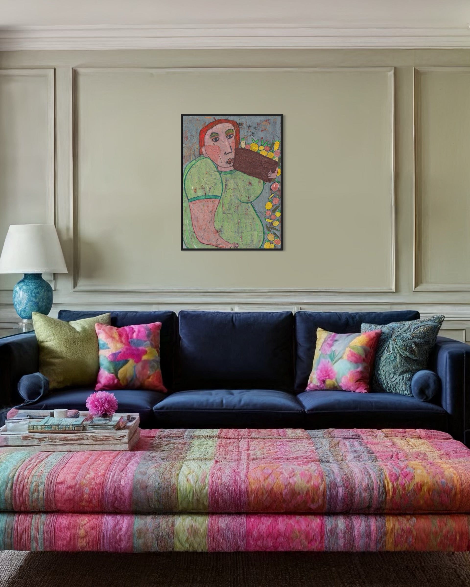 Living room with a navy blue sofa, colorful cushions, and a patterned ottoman.
