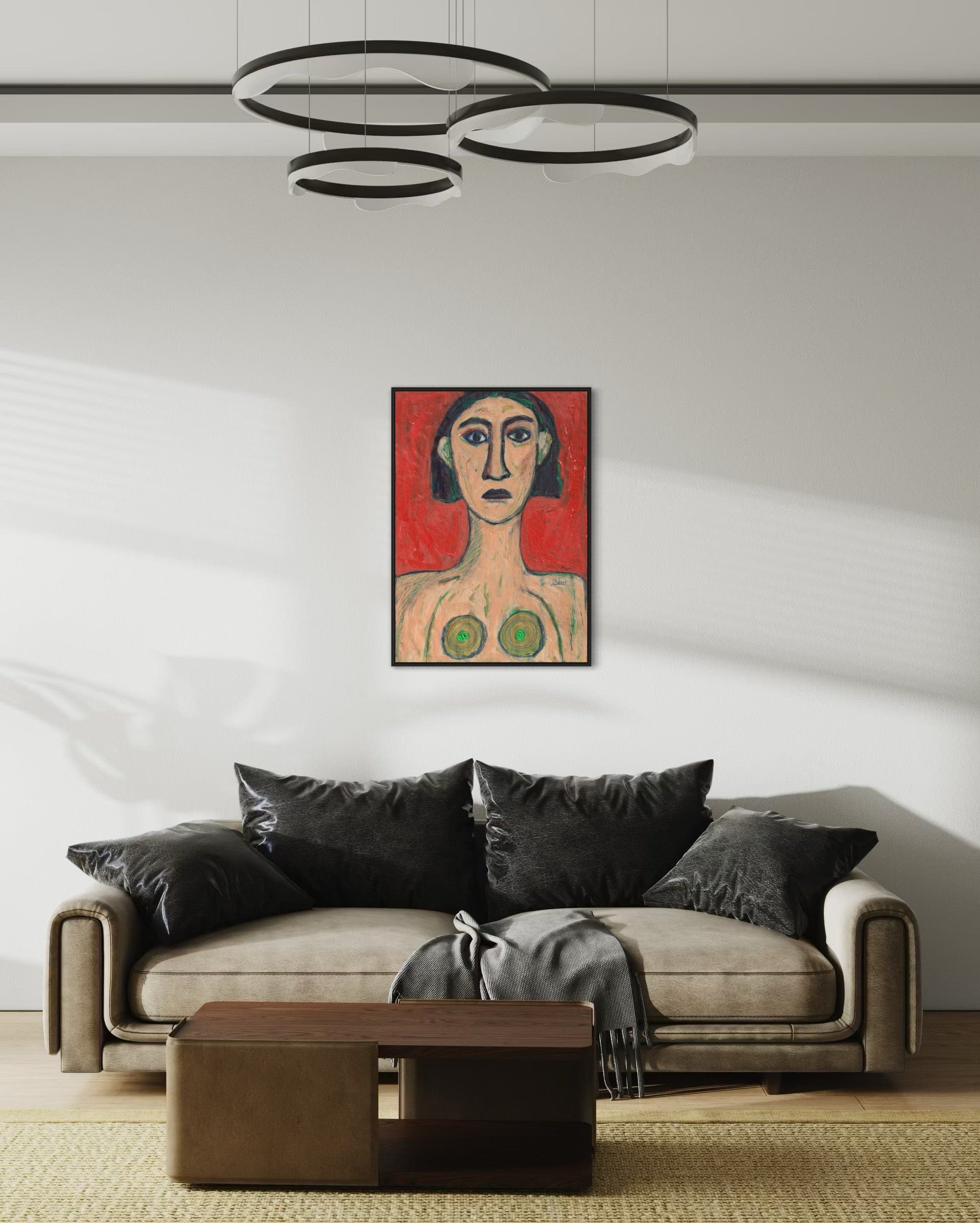 Modern living room with a sofa, coffee table, and artwork on the wall.