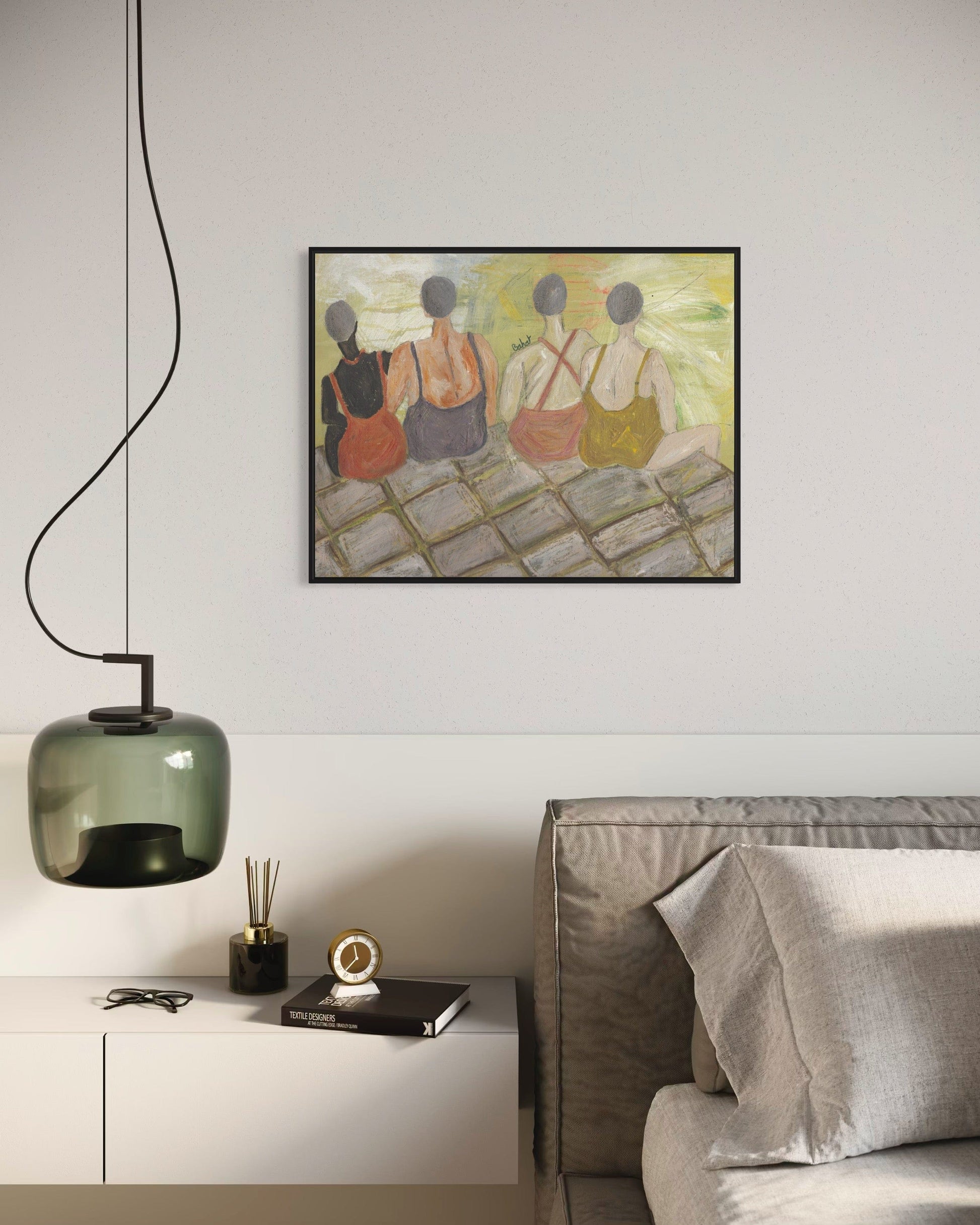 Modern living room with a painting on the wall, a green pendant light, and a gray sofa.