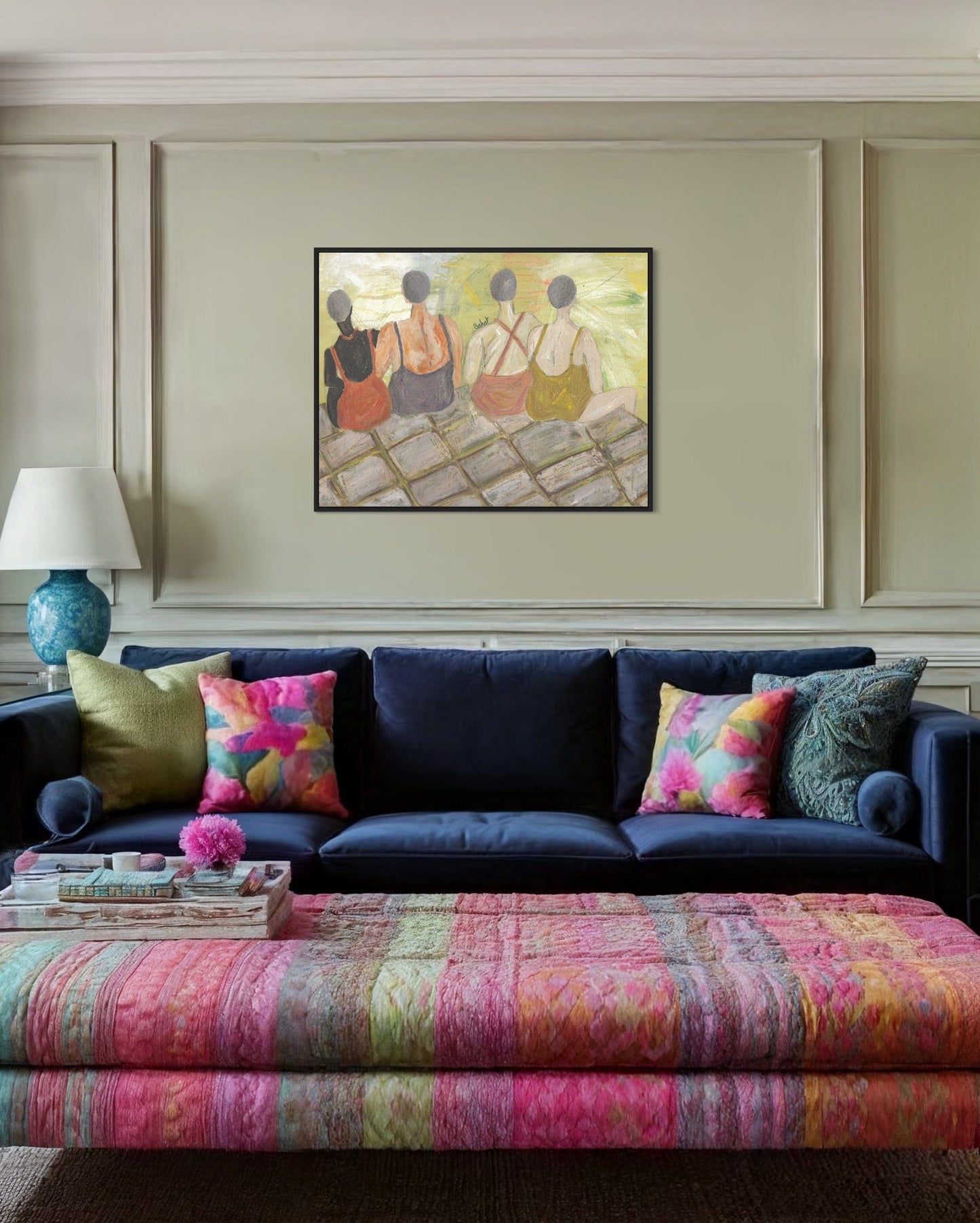 Living room with a navy blue sofa, colorful pillows, and a patterned ottoman.