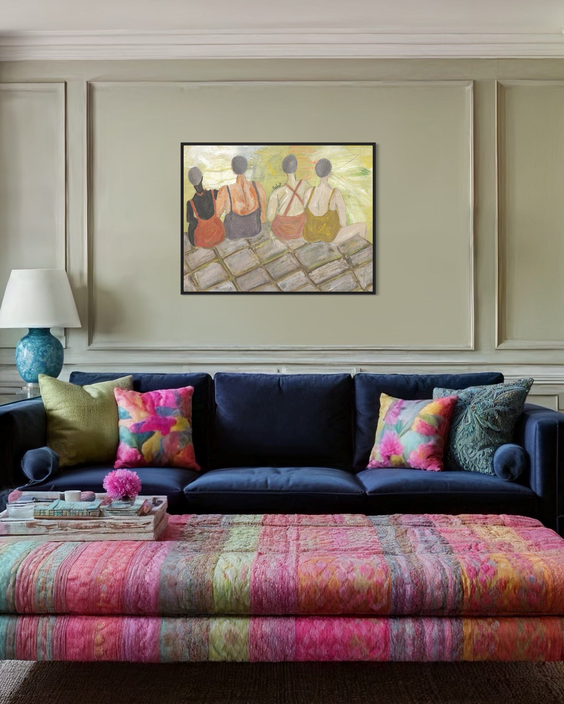 Living room with a navy blue sofa, colorful pillows, and a patterned ottoman.