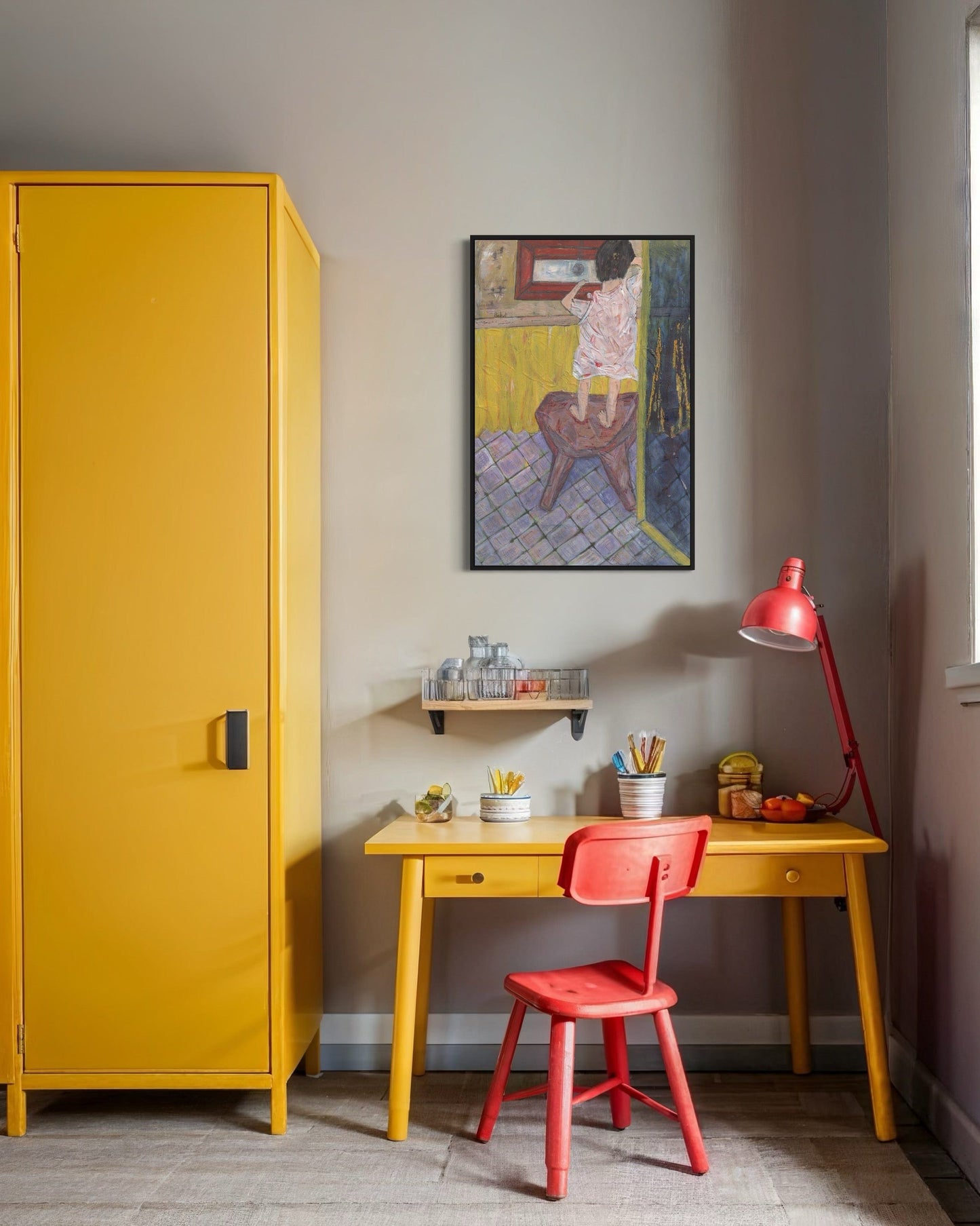 Yellow cabinet, red chair, and desk with a colorful painting on the wall in a room.