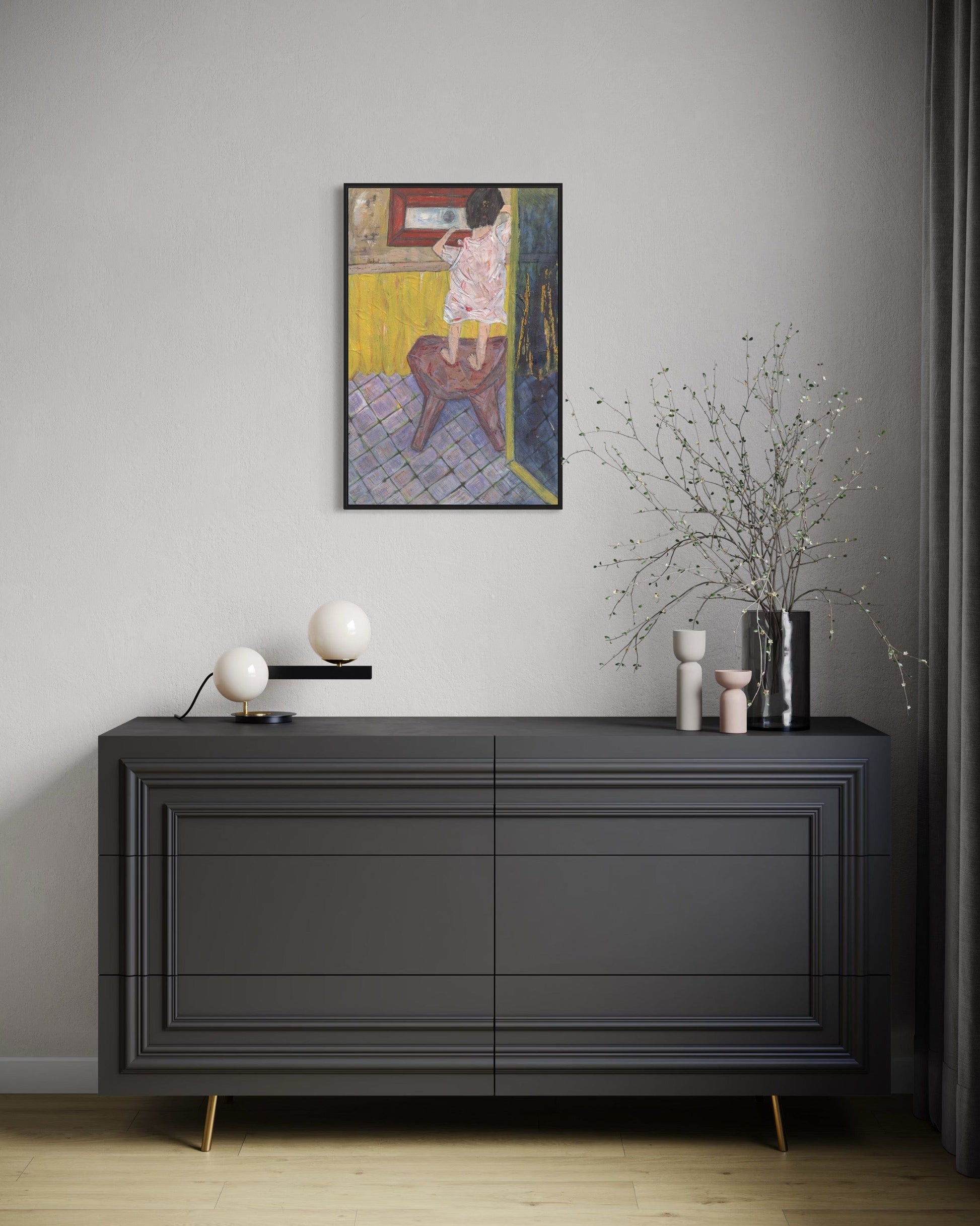 Modern interior with a dark gray dresser, decorative items, and a framed painting on a light gray wall.
