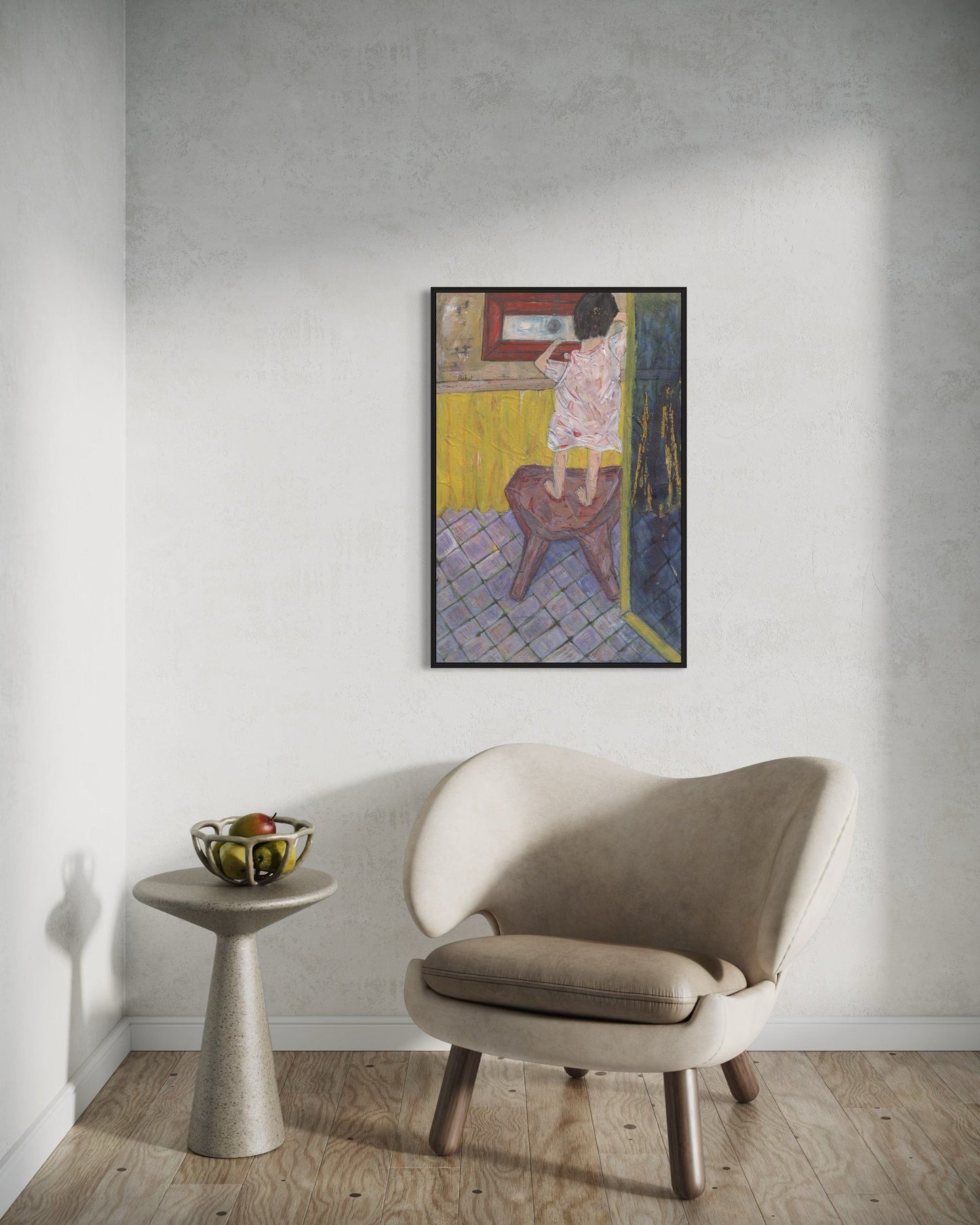 Beige armchair in a room with a wall painting and small table.