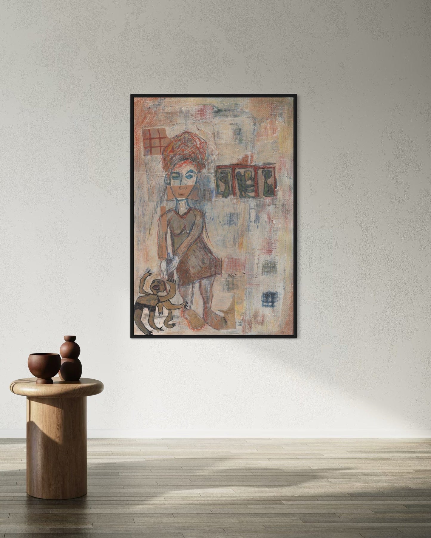 Framed artwork of a person with a colorful abstract design on a wall above a wooden side table.