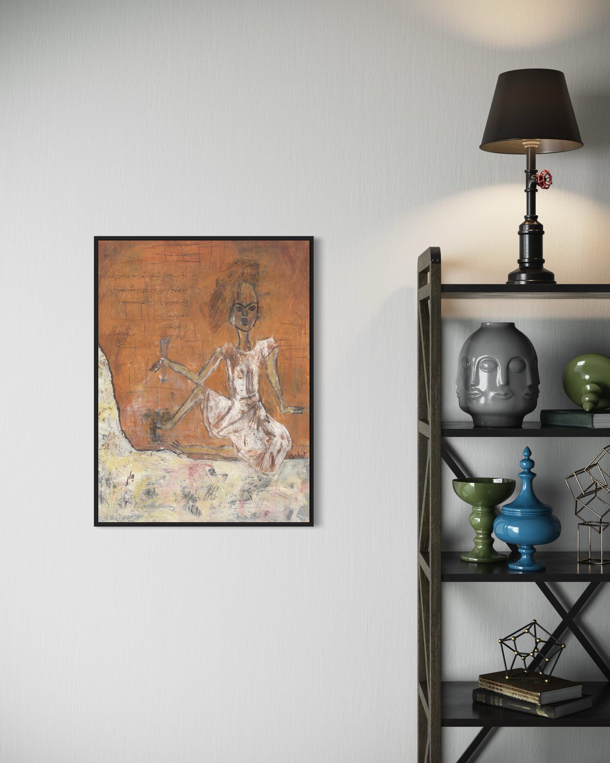 Framed artwork on a wall next to a shelf with decorative items