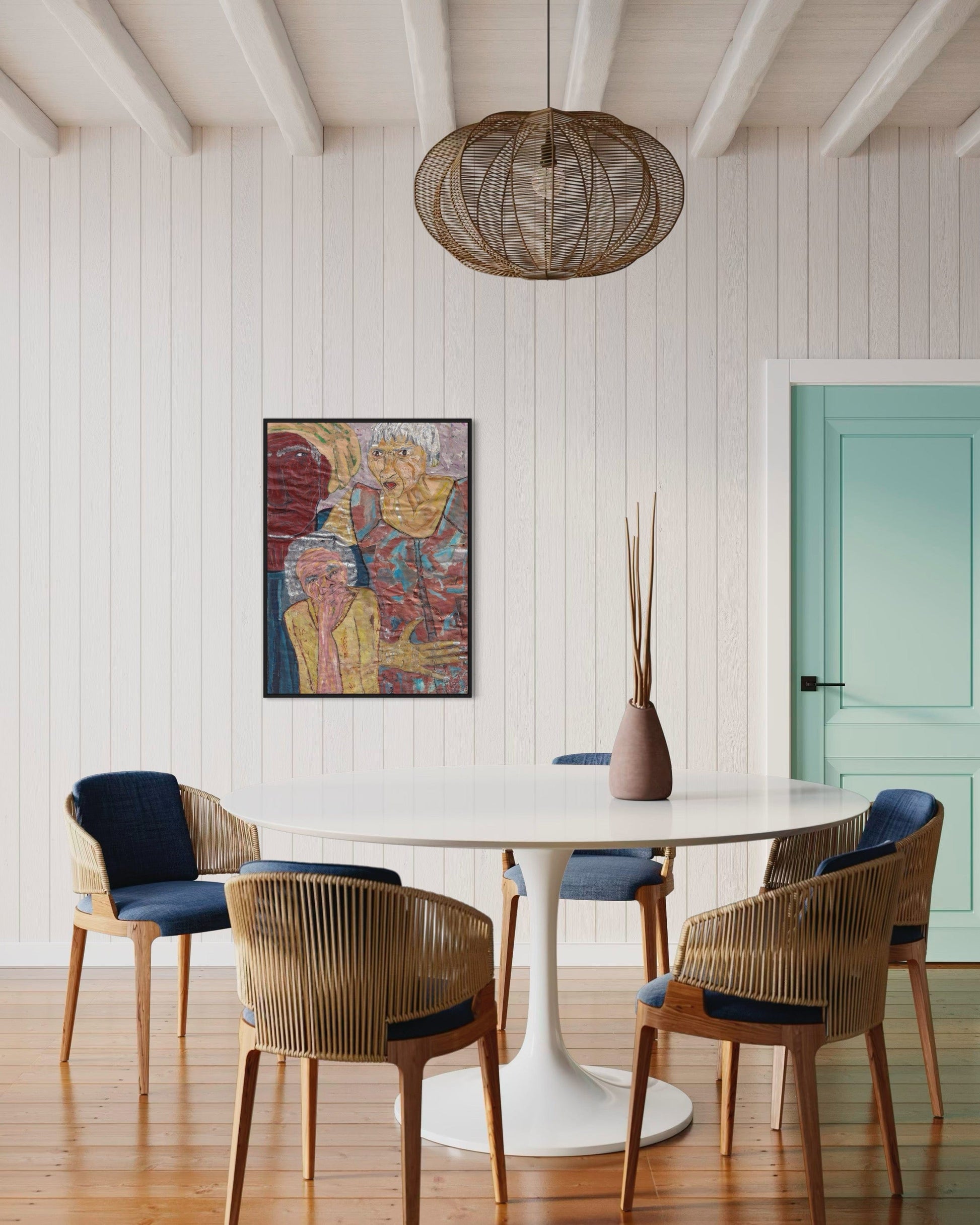 Dining room with a round white table and wicker chairs against a white paneled wall.