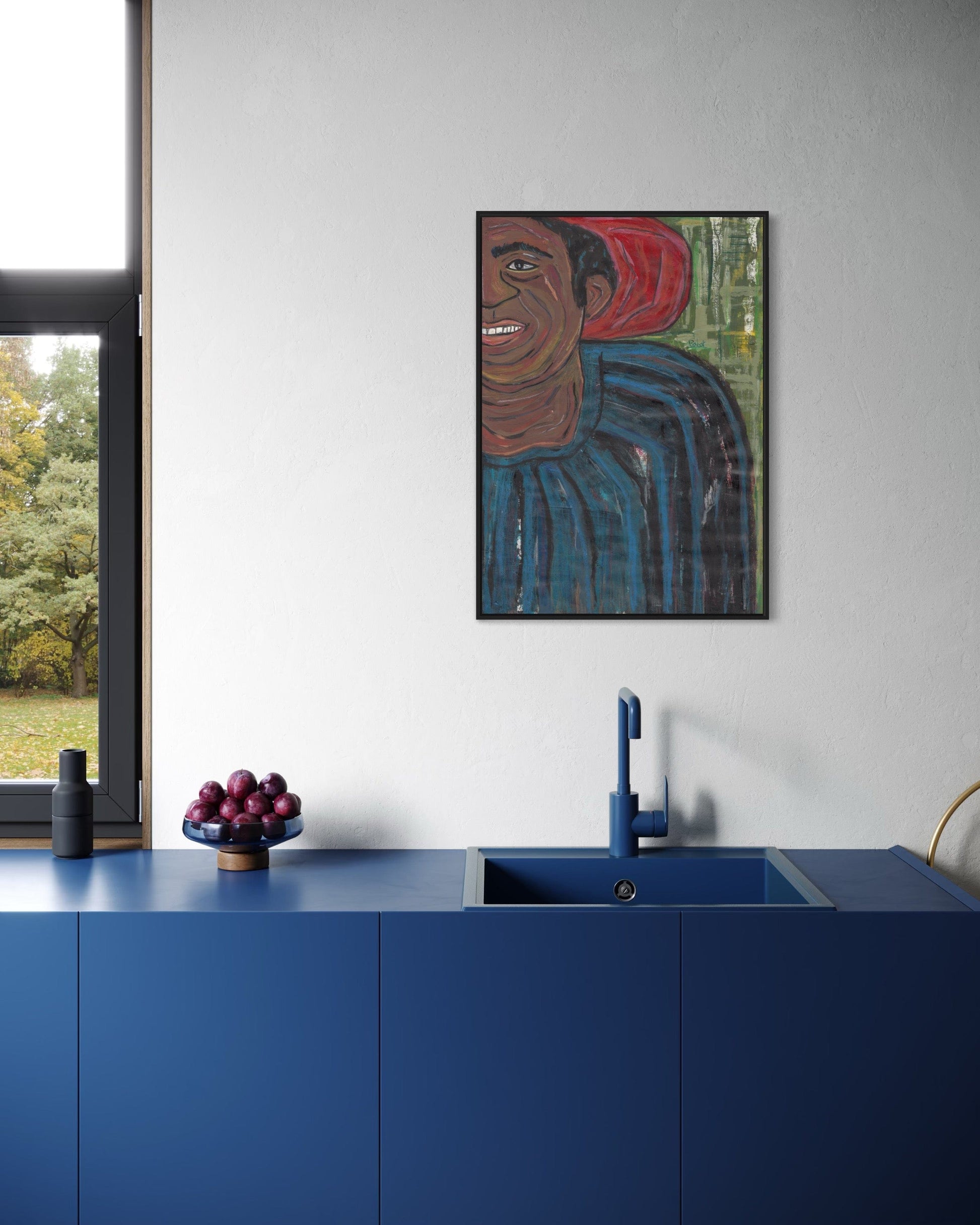Modern kitchen with blue cabinets, a sink, and a framed artwork on the wall.