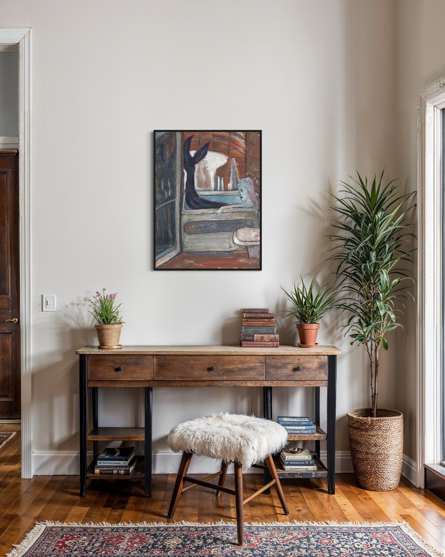 Wooden desk with plants and a painting in a room with a rug and window.