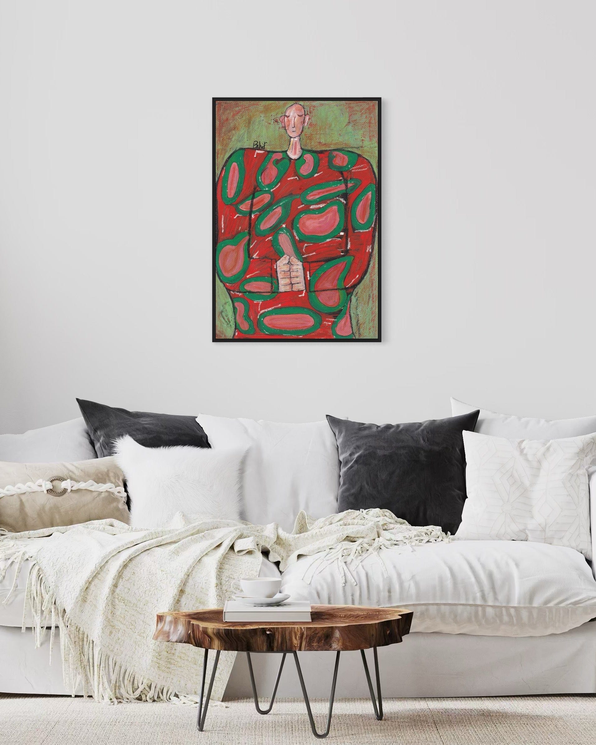 Living room with a white sofa, wooden coffee table, and abstract art on the wall.