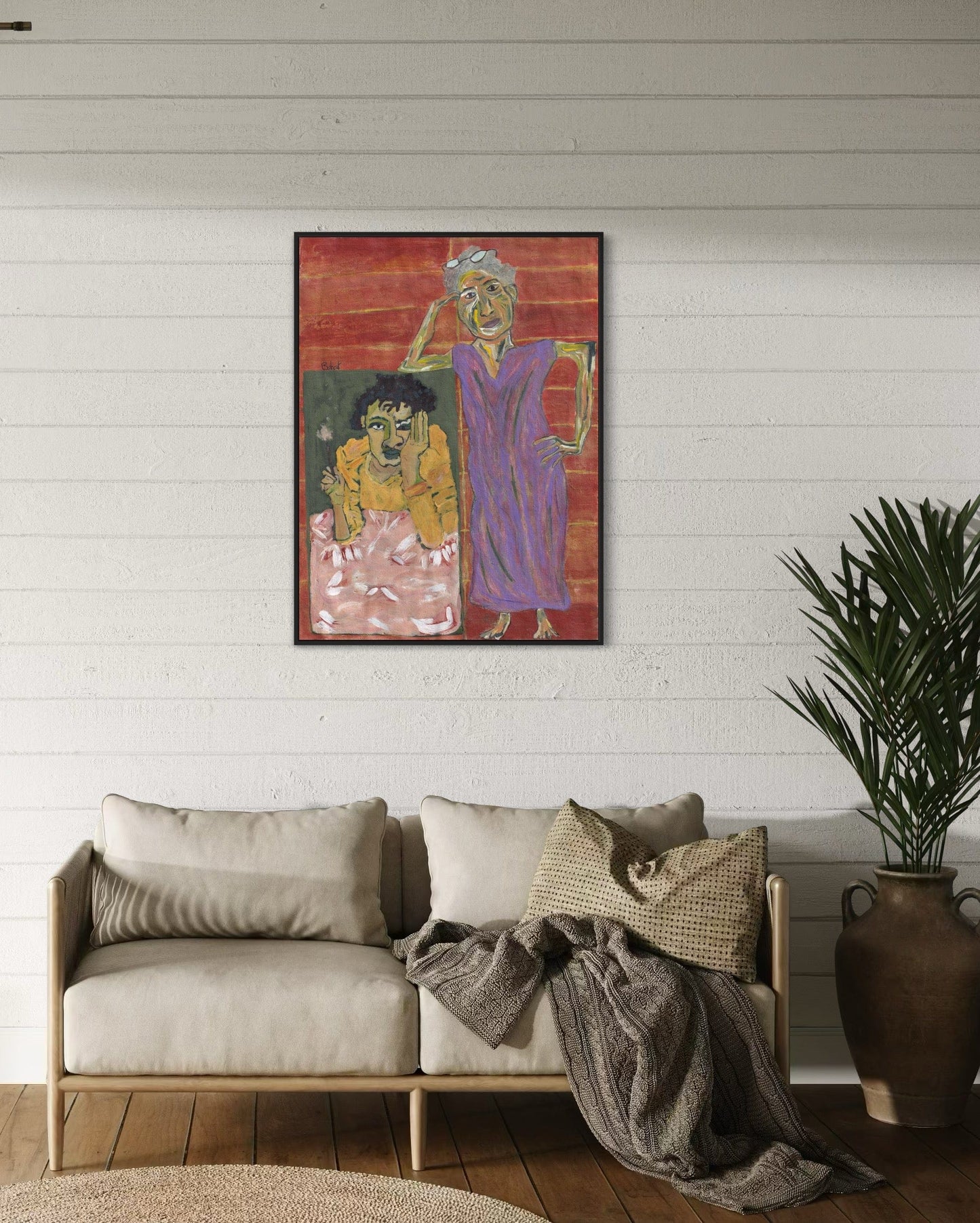 Colorful abstract painting on a wall above a beige sofa with decorative pillows and a plant.