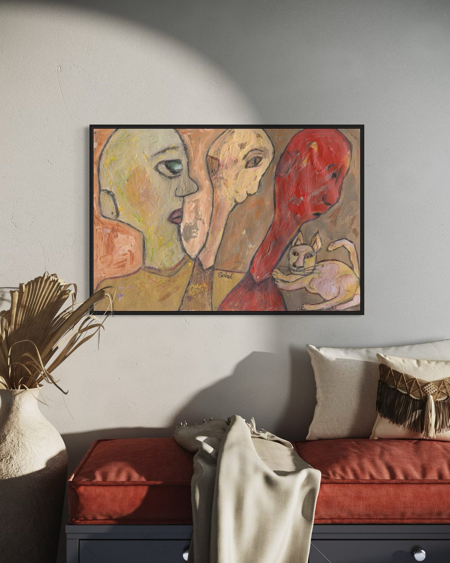 Abstract painting of two faces and a cat on a wall in a living room.