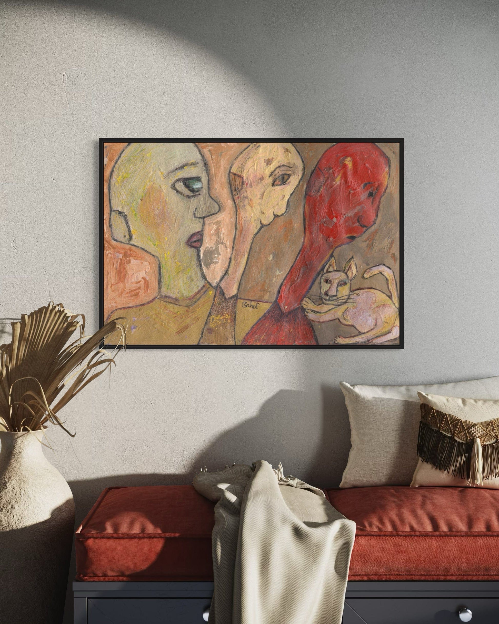 Abstract painting of two faces and a cat on a wall in a living room.