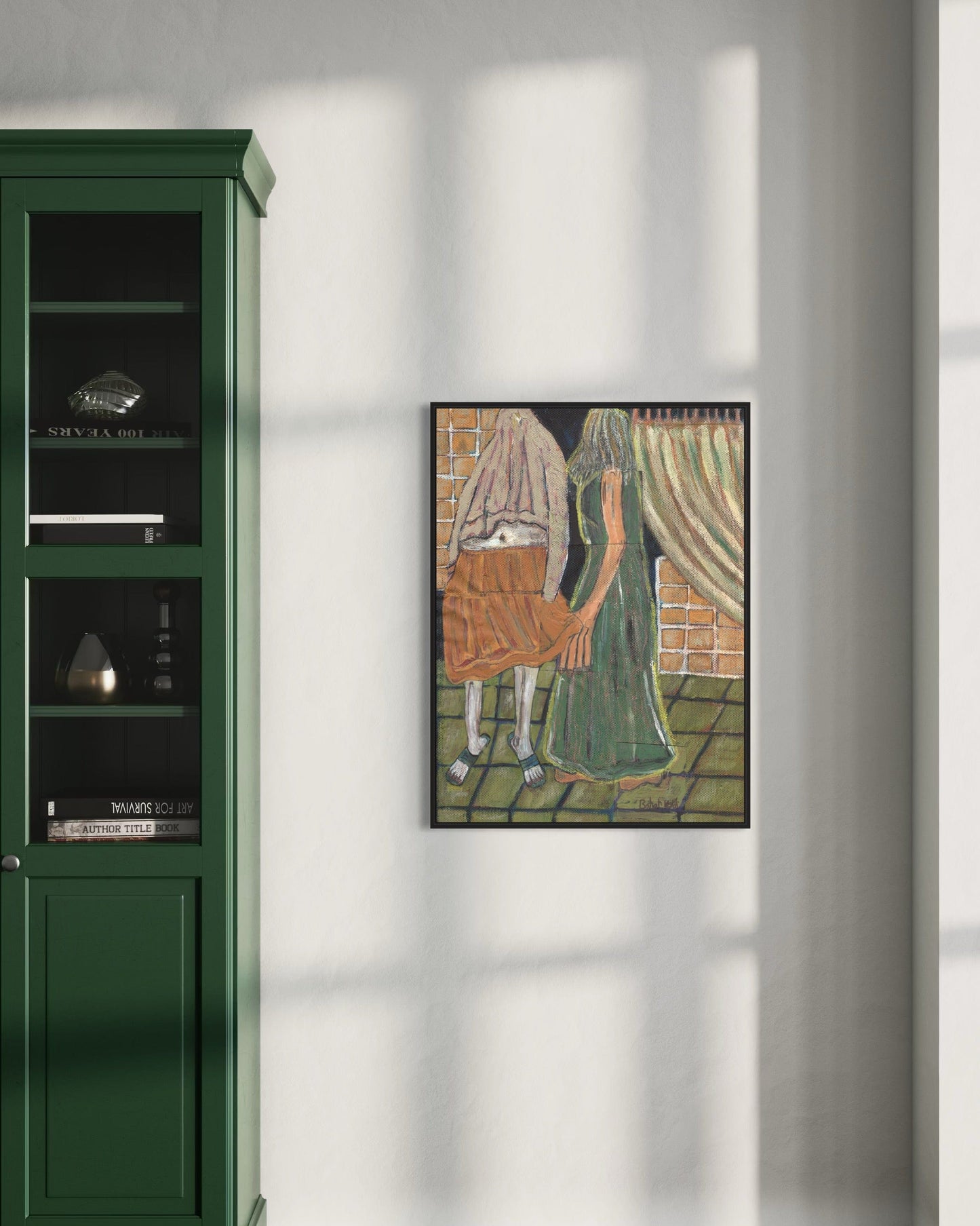Framed artwork of a woman with a basket on a wall next to a green cabinet.