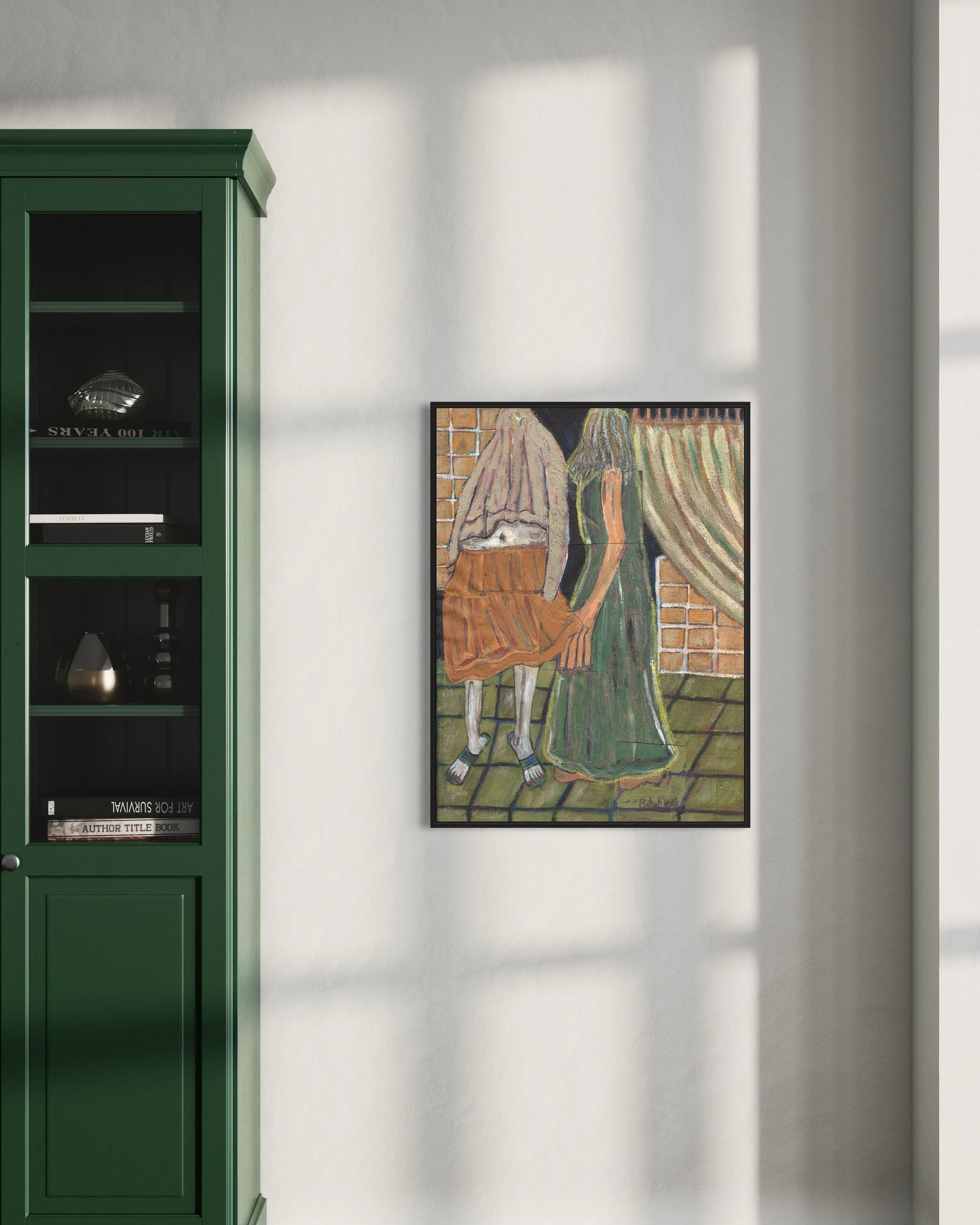 Framed artwork of a woman with a basket on a wall next to a green cabinet.