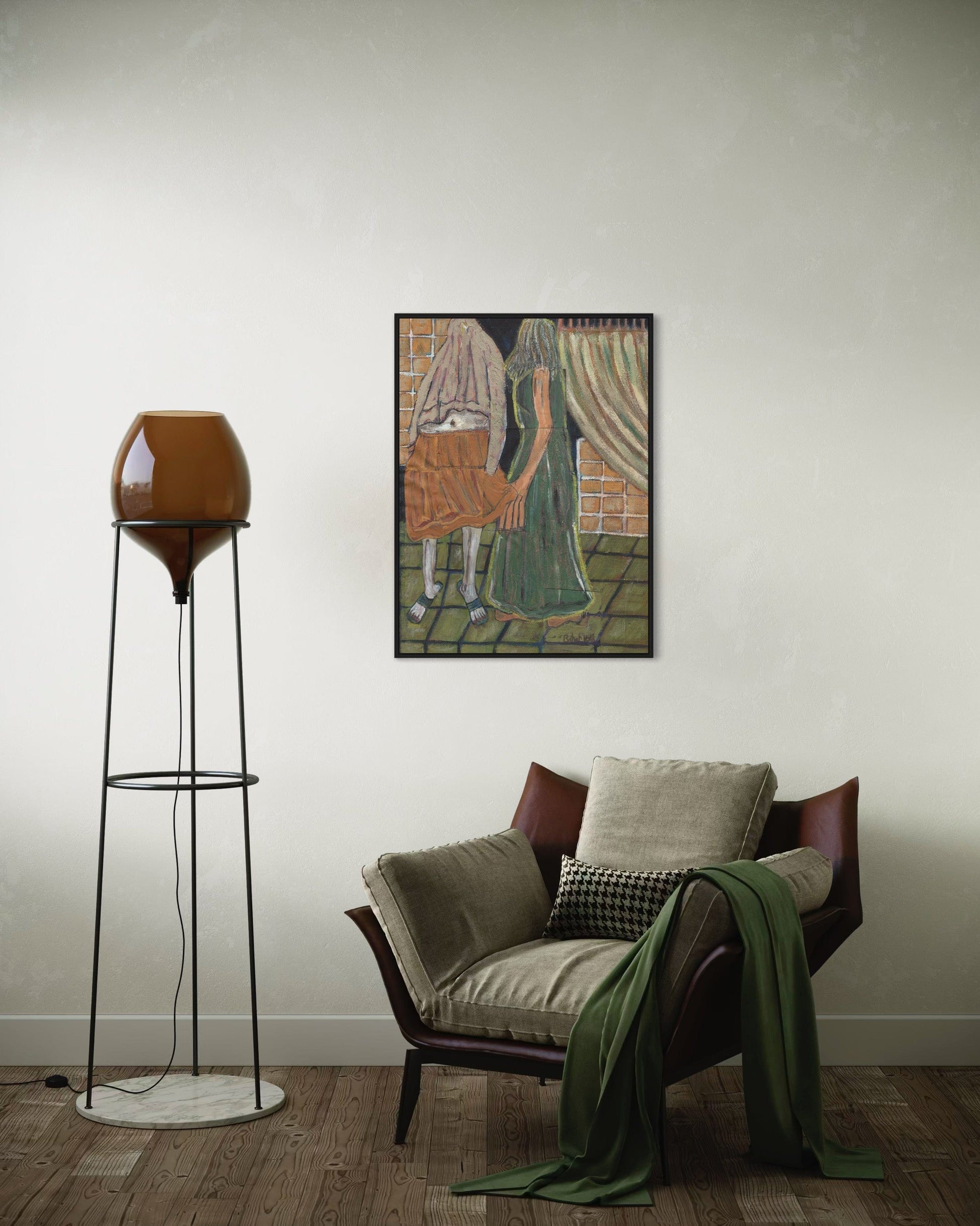 Living room with a chair, lamp, and framed artwork on the wall.