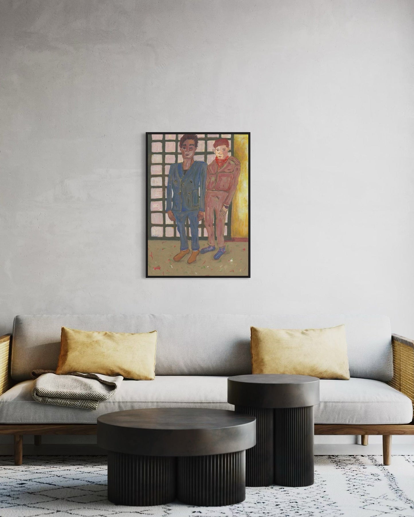 Living room with a gray sofa, coffee table, and wall art of two people.