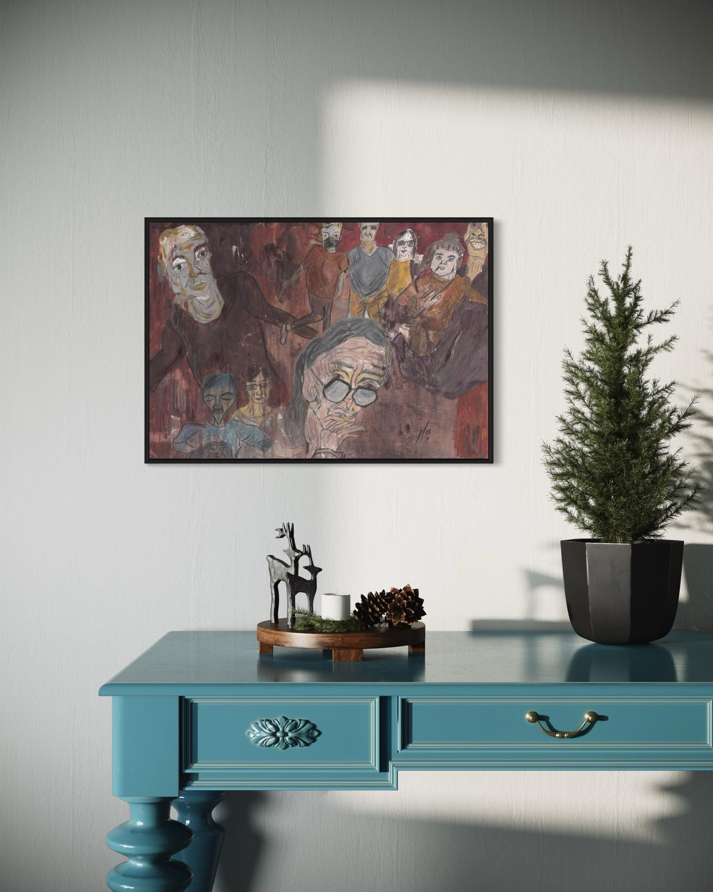 Teal desk with decorative items and a framed painting on a white wall.
