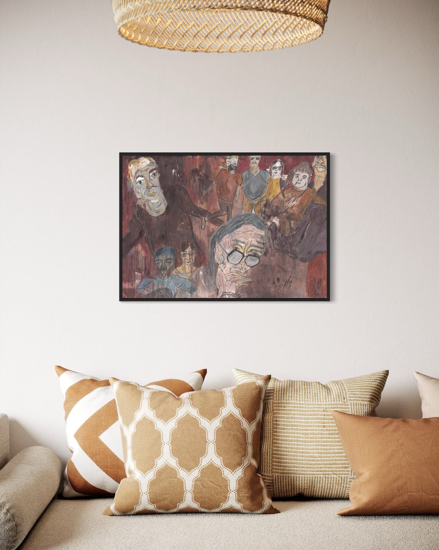 Framed artwork on a wall above a sofa with patterned cushions.