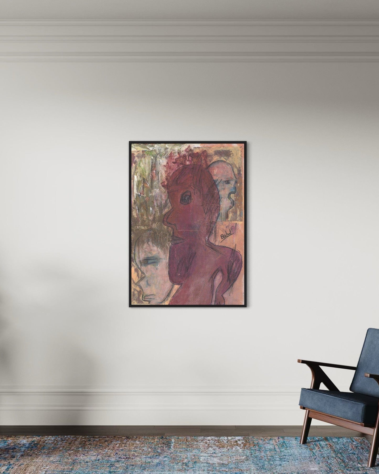 Framed abstract artwork on a wall with a blue armchair below