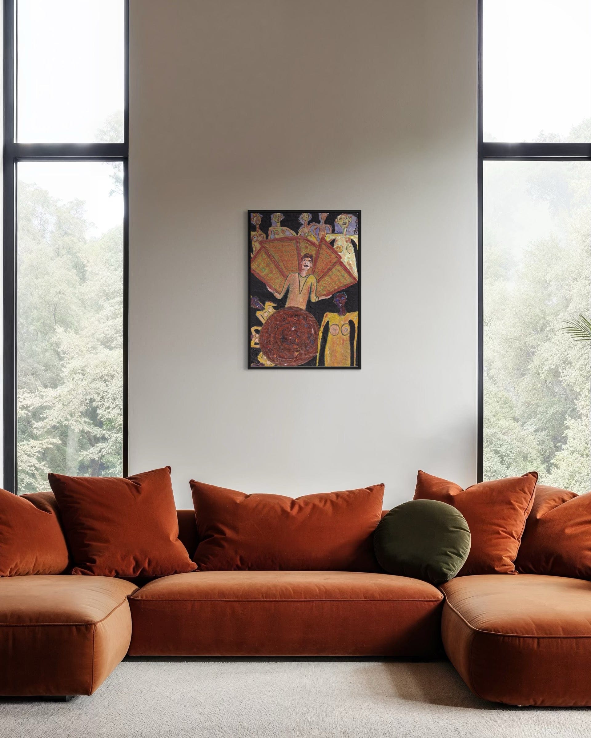 Orange sofa with decorative pillows in a room with large windows and a wall poster.
