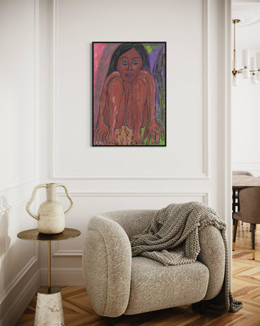 Artistic depiction of a person on a wall above a cozy armchair with a blanket.