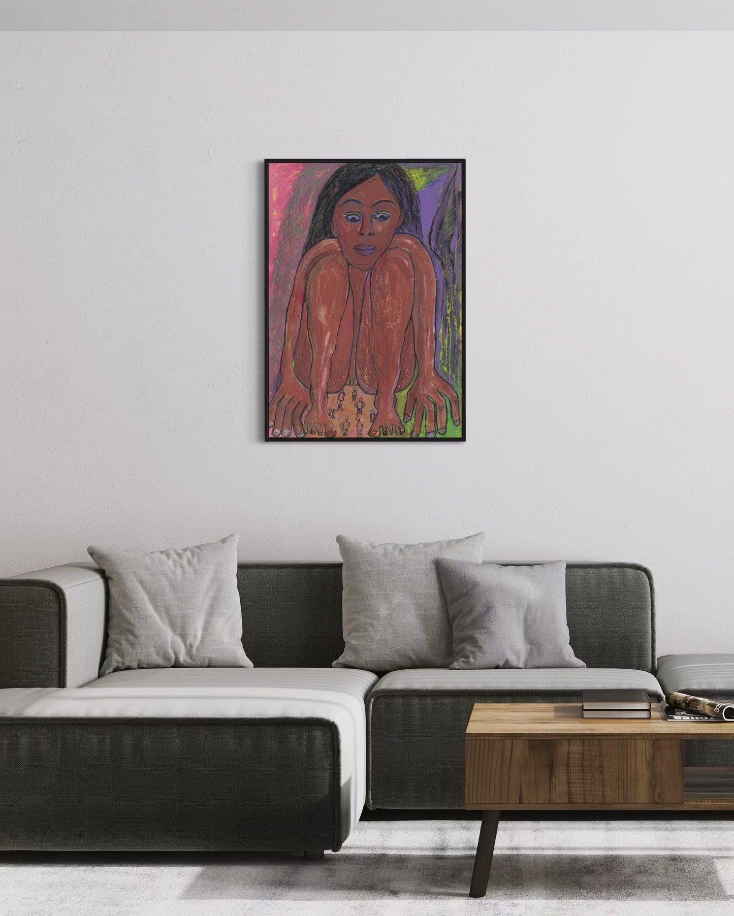 Framed artwork of a woman on a wall above a modern sofa in a living room.