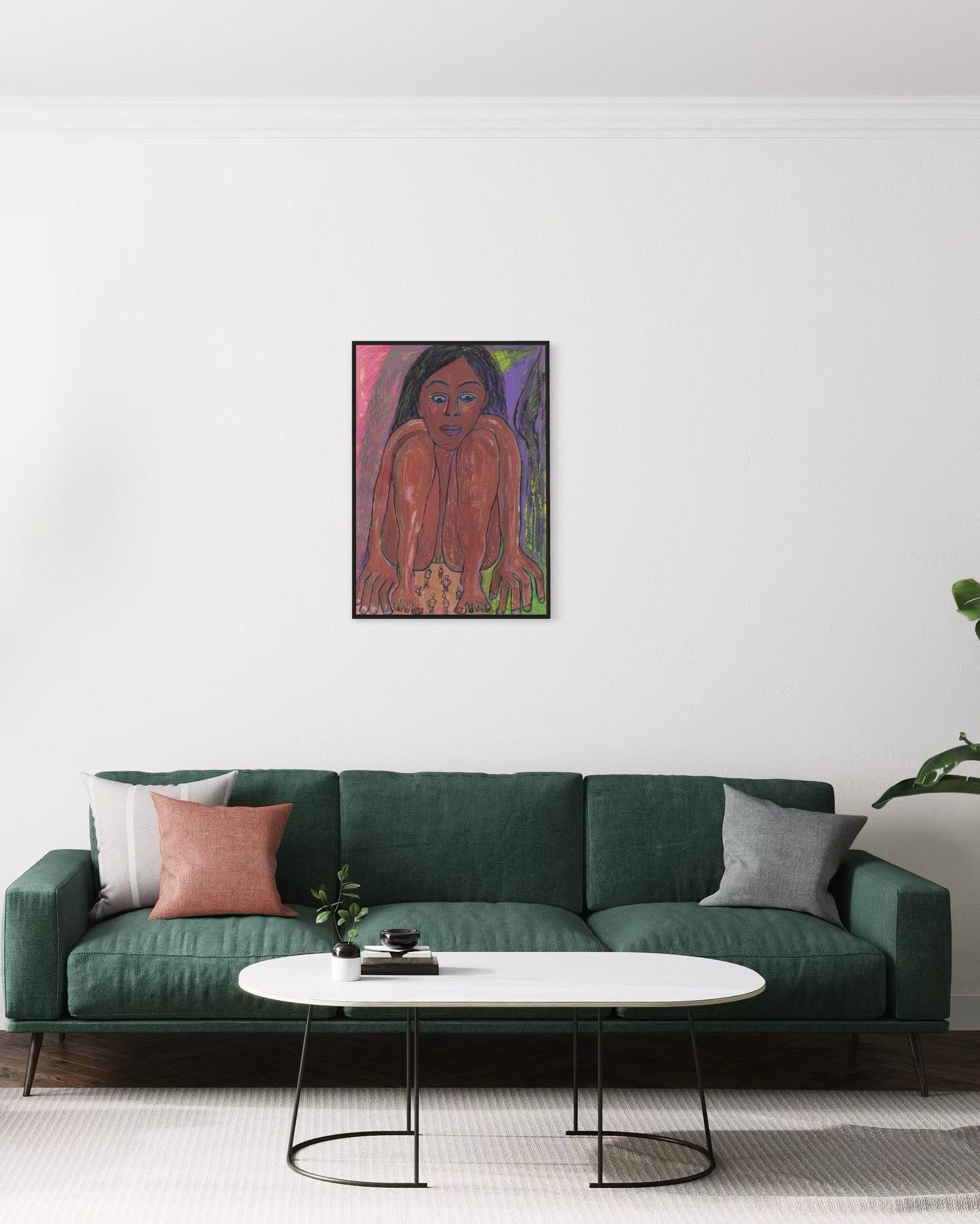 Green sofa with decorative pillows in a living room setting, featuring a painting of a woman on the wall.