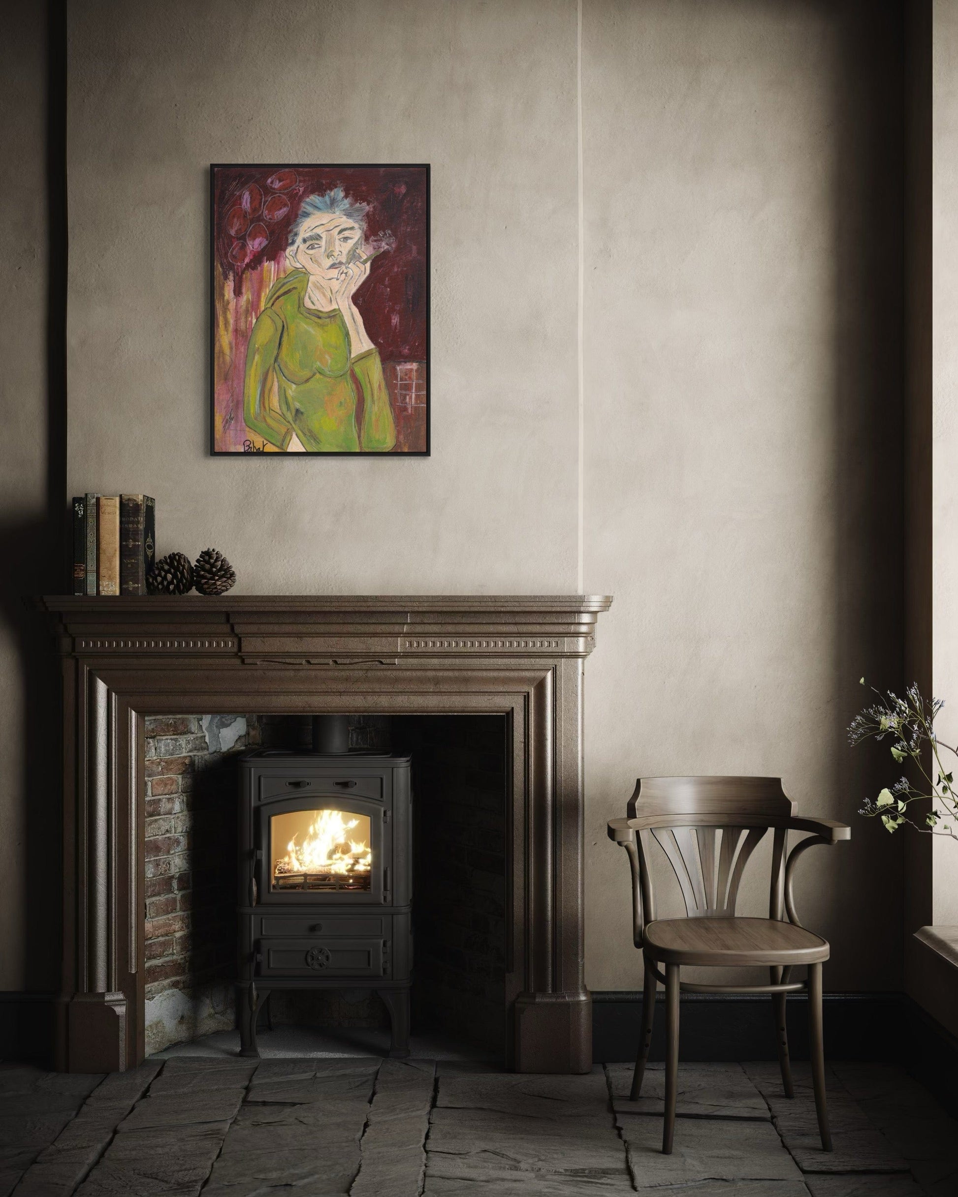 Room interior with a fireplace, chair, and framed artwork on the wall.