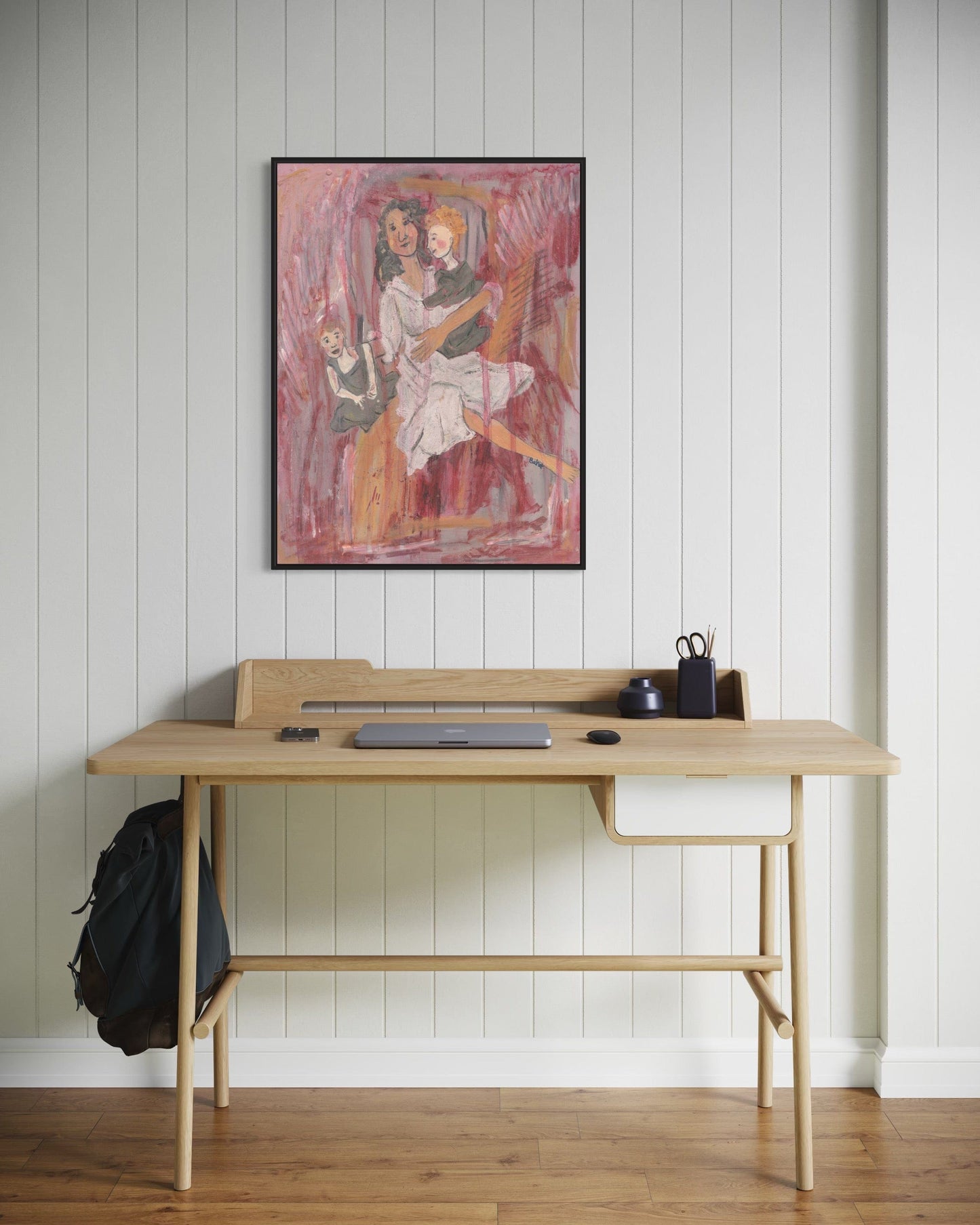 Wooden desk with a backpack and items against a white paneled wall with a framed painting.
