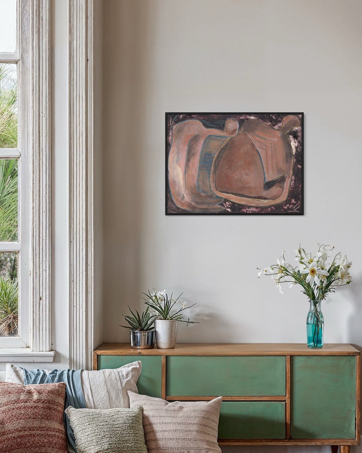 Living room with a green cabinet, sofa, and abstract painting on the wall.