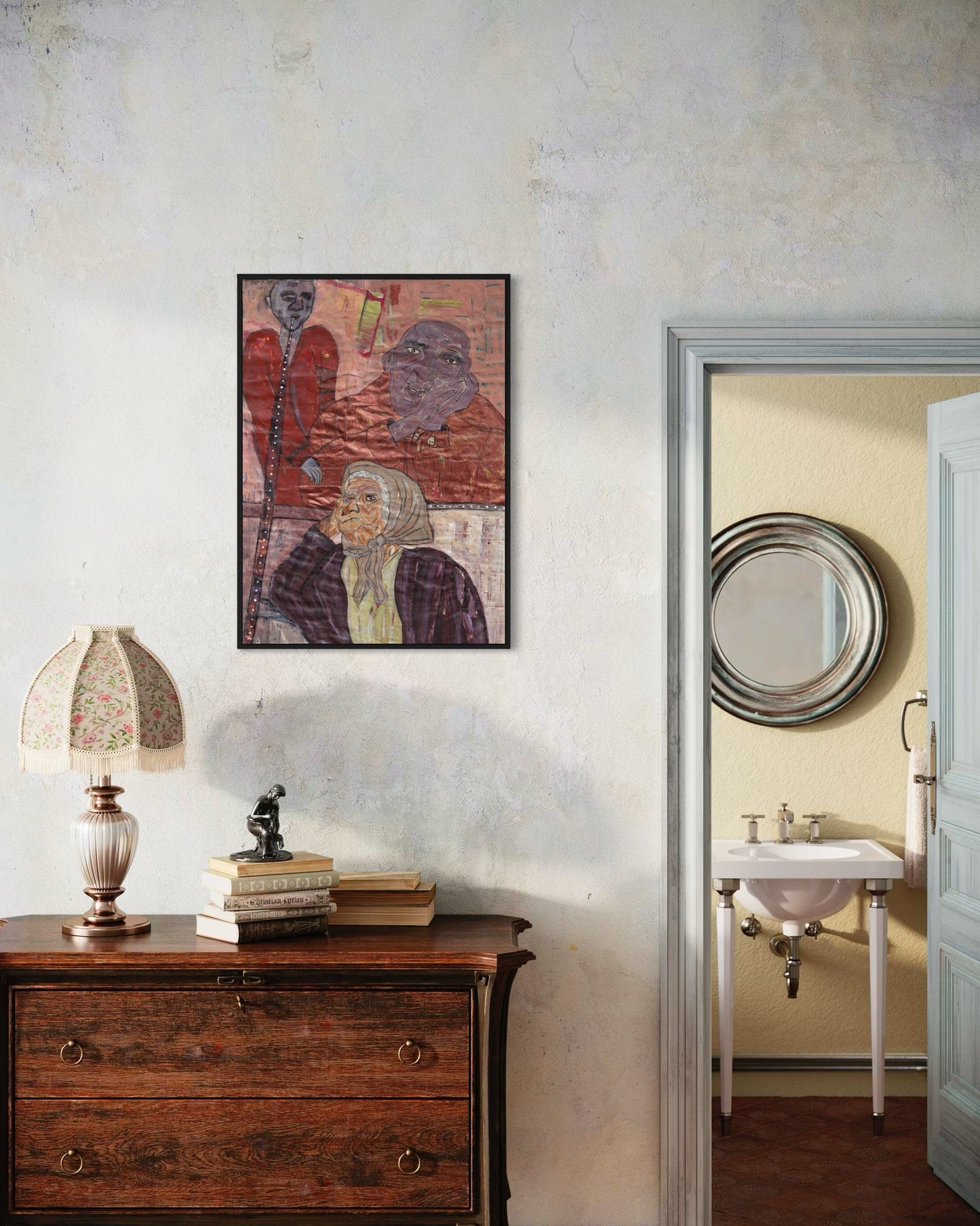 Room interior with a wooden dresser, lamp, and framed artwork on a white wall.