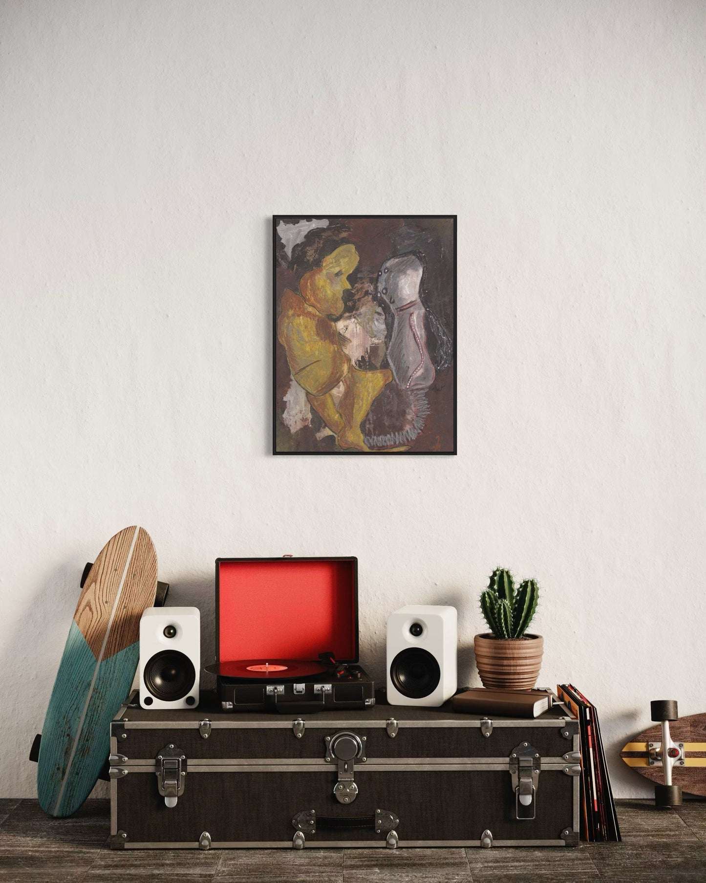 Decorative setup with a framed artwork, speakers, a red screen, and a cactus on a shelf.