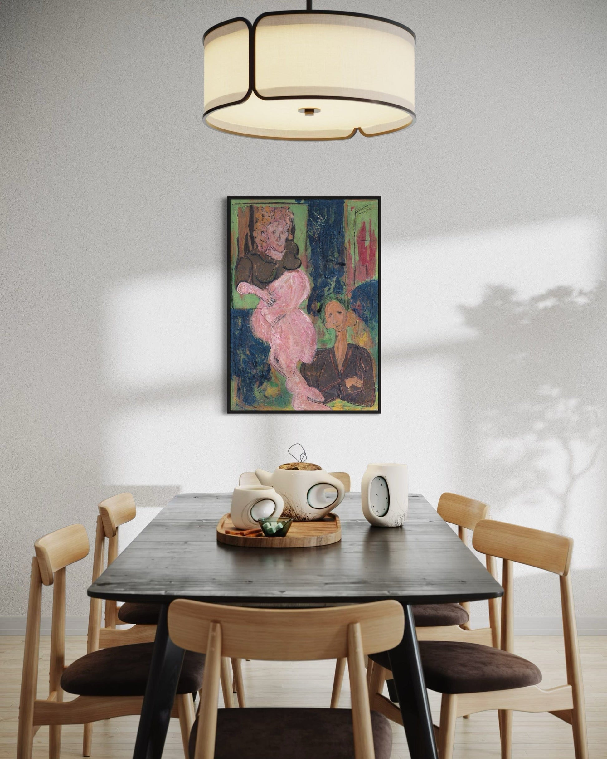 Dining room with a black table and wooden chairs, featuring a colorful painting on the wall.