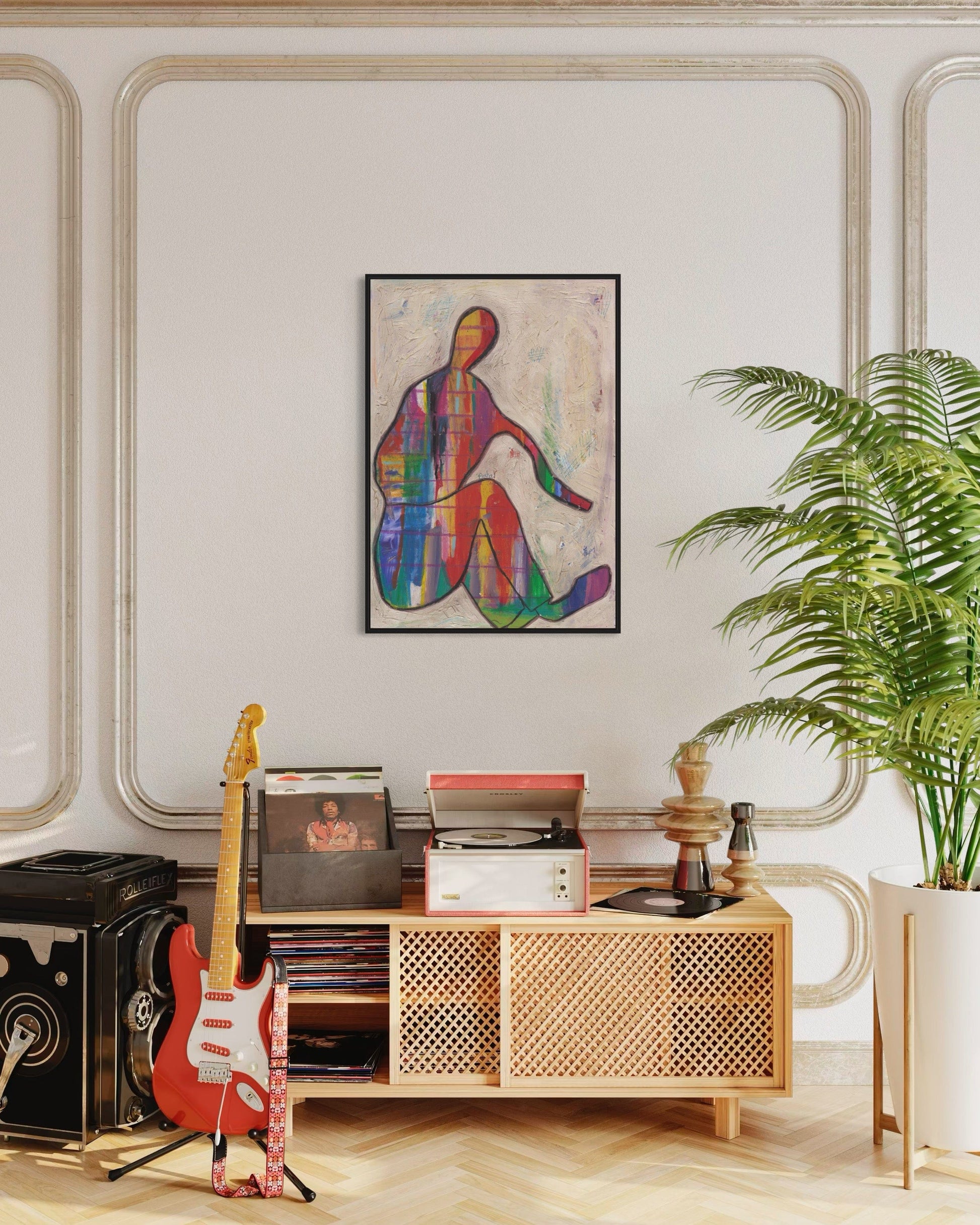 Living room with a wooden console table, guitar, and colorful abstract art on the wall.