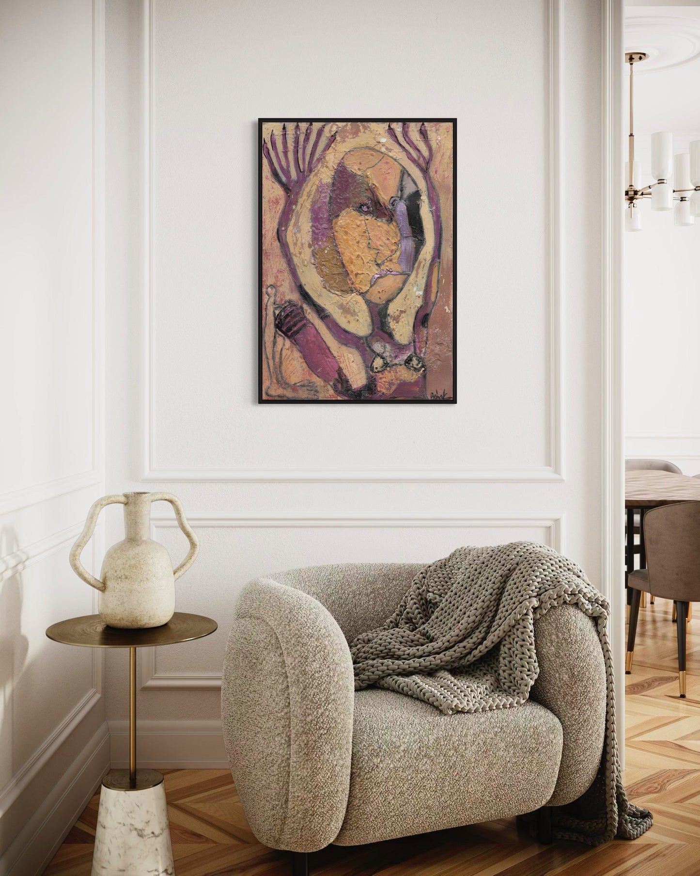 Cozy living room with a textured armchair, side table, and abstract art on the wall.